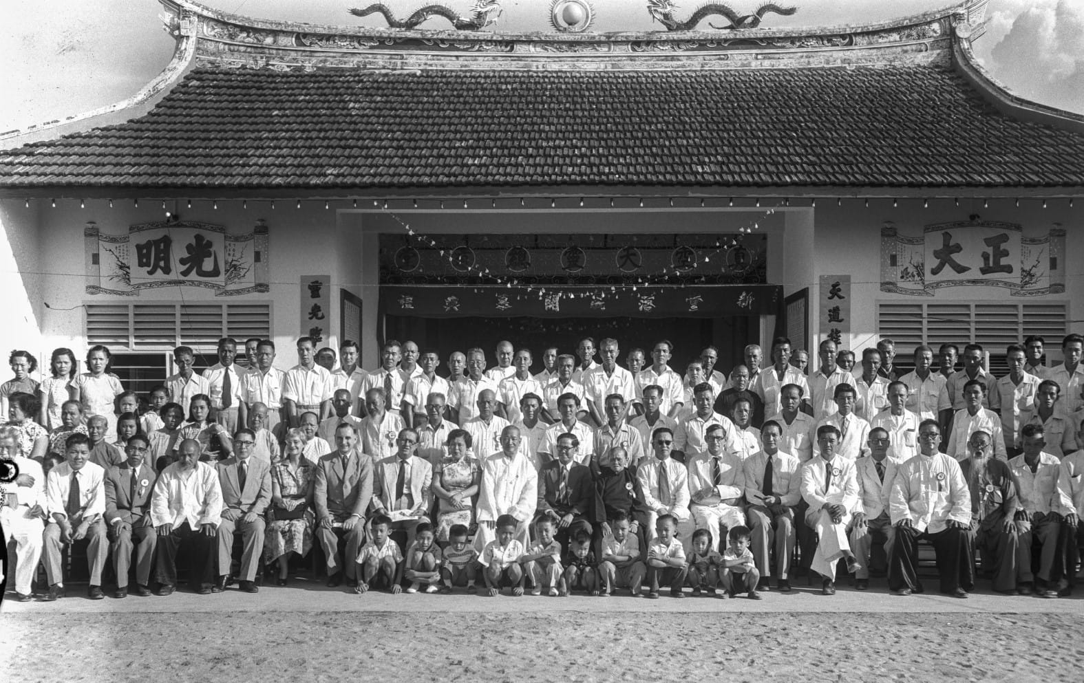 Group photograph taken with Chief Minister Lim Yew Hock during the opening of the Opium Addicts' Treatment Association's Chinese temple on Changi Road, 1956. Ministry of Information and the Arts Collection, courtesy of National Archives of Singapore.