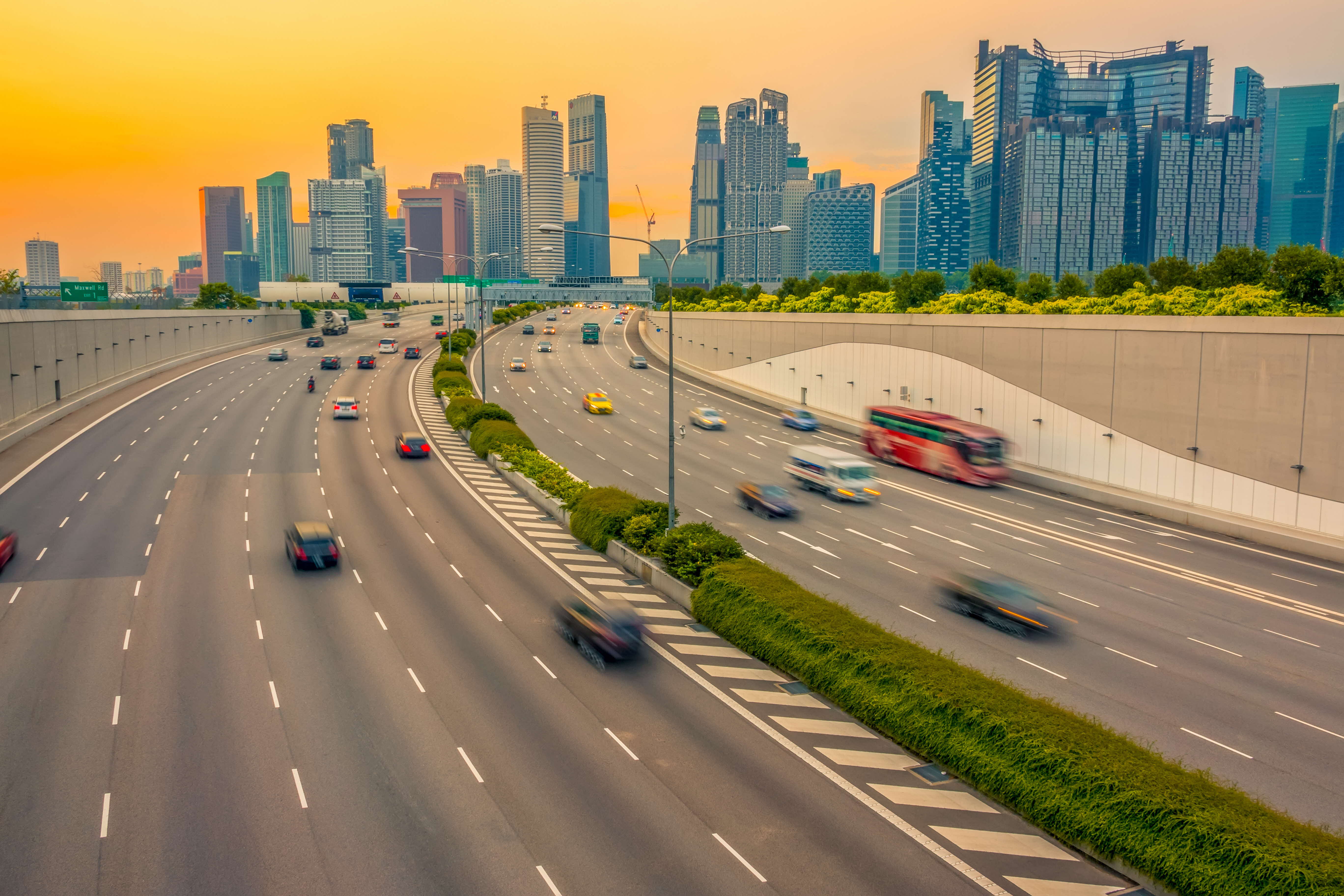 Cars moving on a Singapore expressway with ERP gantry near CBD