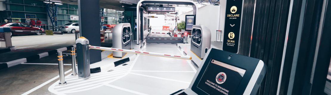 Singapore Woodlands Checkpoint showing automated immigration clearance and boom barrier.