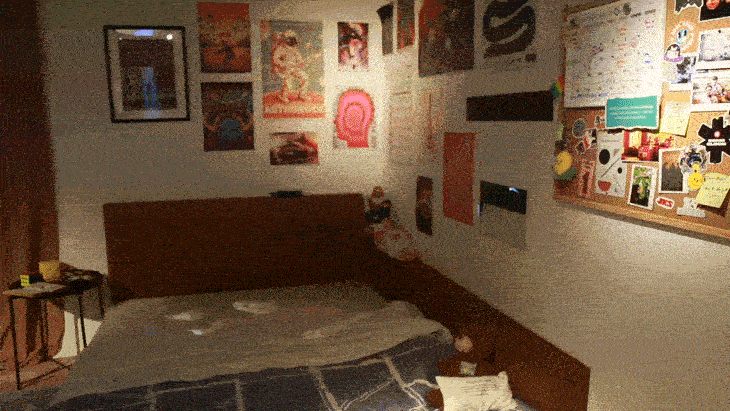 Bedroom with bed, posters on the wall, and a bulletin board covered with notes and images.