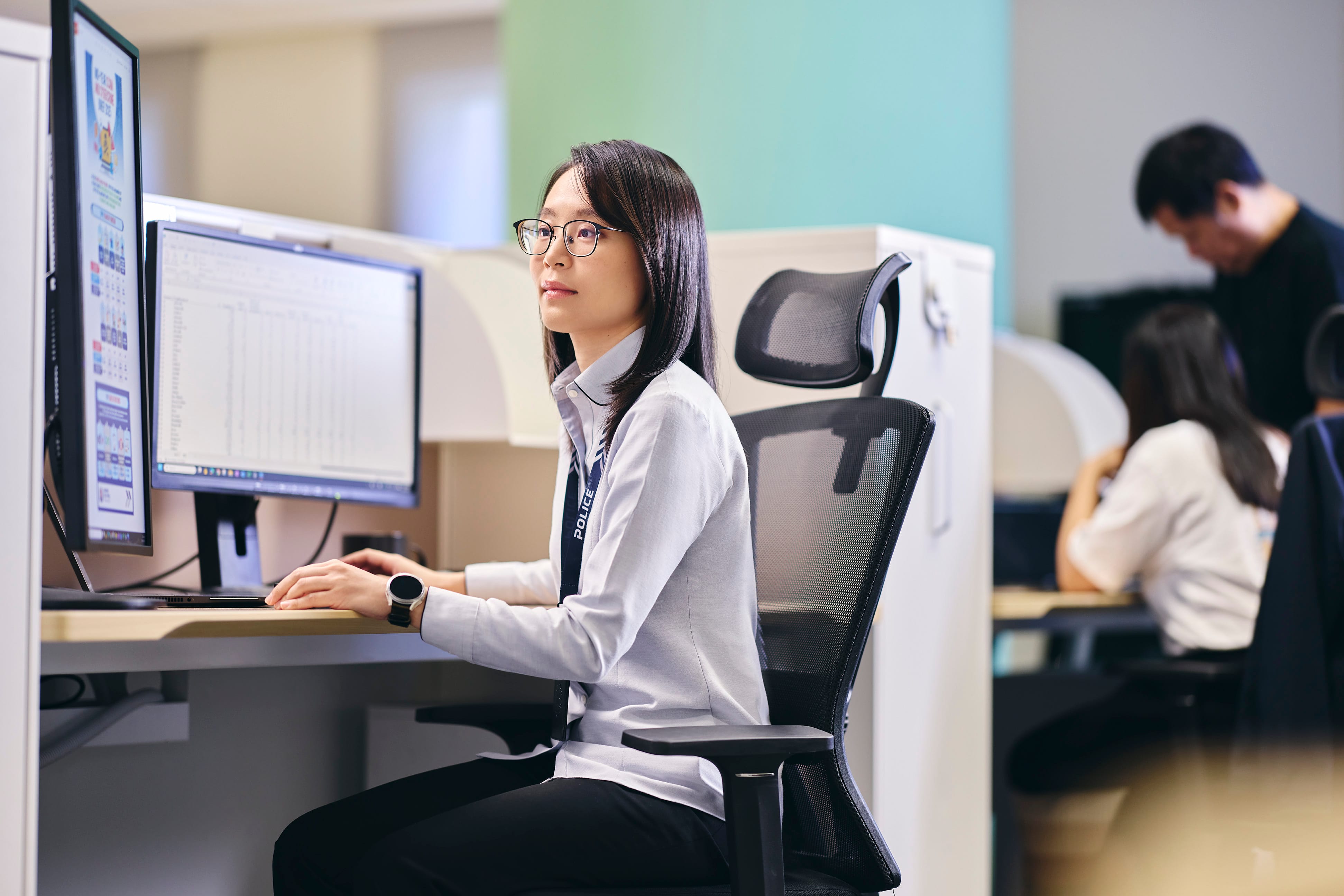 Police Intelligence officer in her office at work