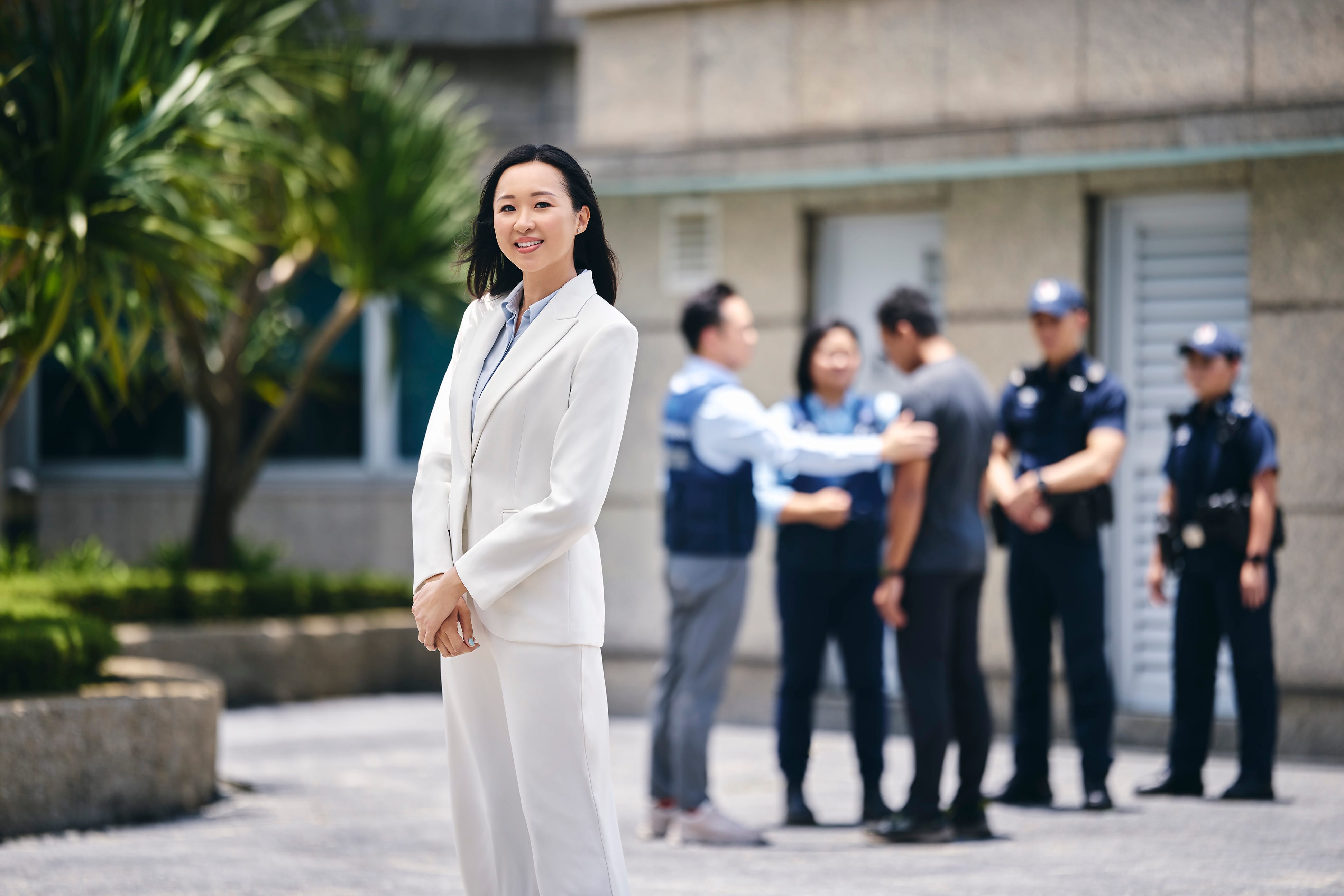 A female Home Team psychologist standing and smiling