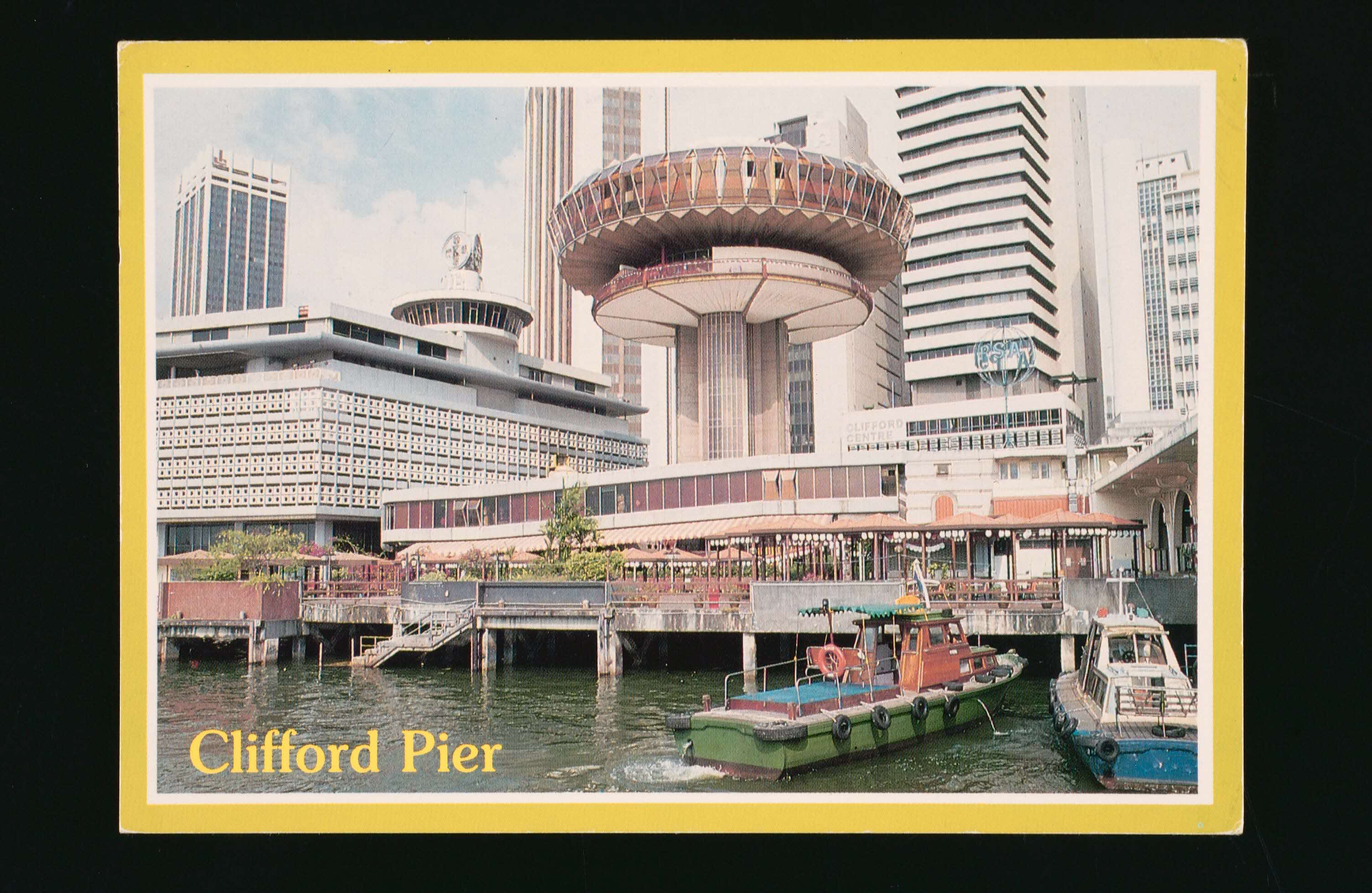 Buildings near Clifford Pier and boats docked on the water, framed by a yellow border.