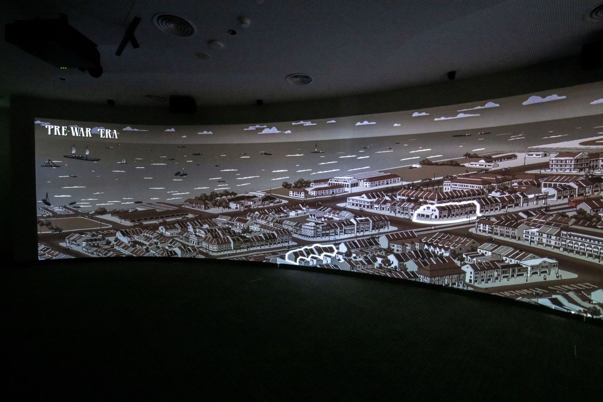 A large screen displays a sepia-toned illustration of a coastal town labeled "Pre-War Era," with ships in the water.