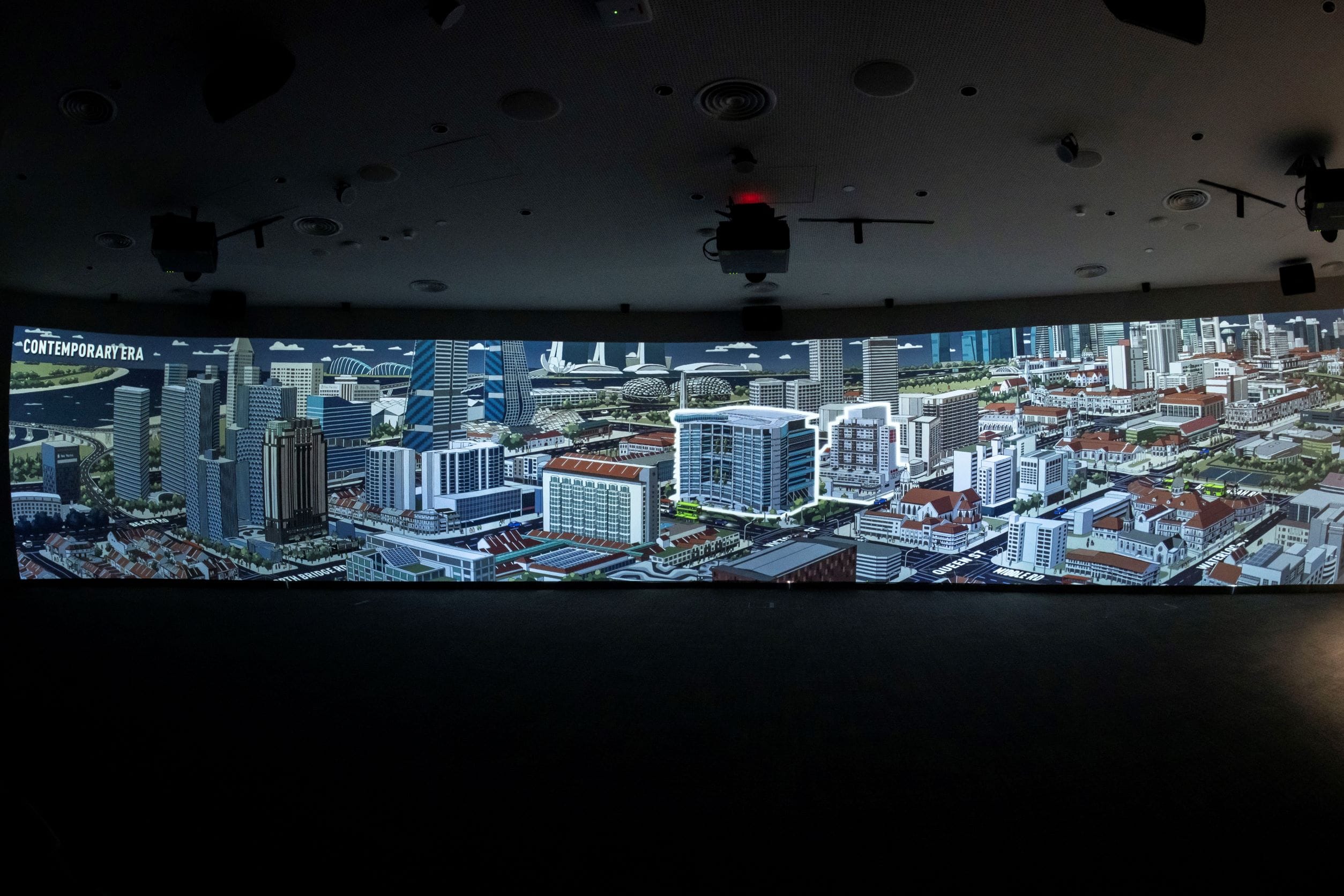 A large panoramic screen displays a detailed cityscape labeled "Contemporary Era," featuring modern buildings and infrastructure.