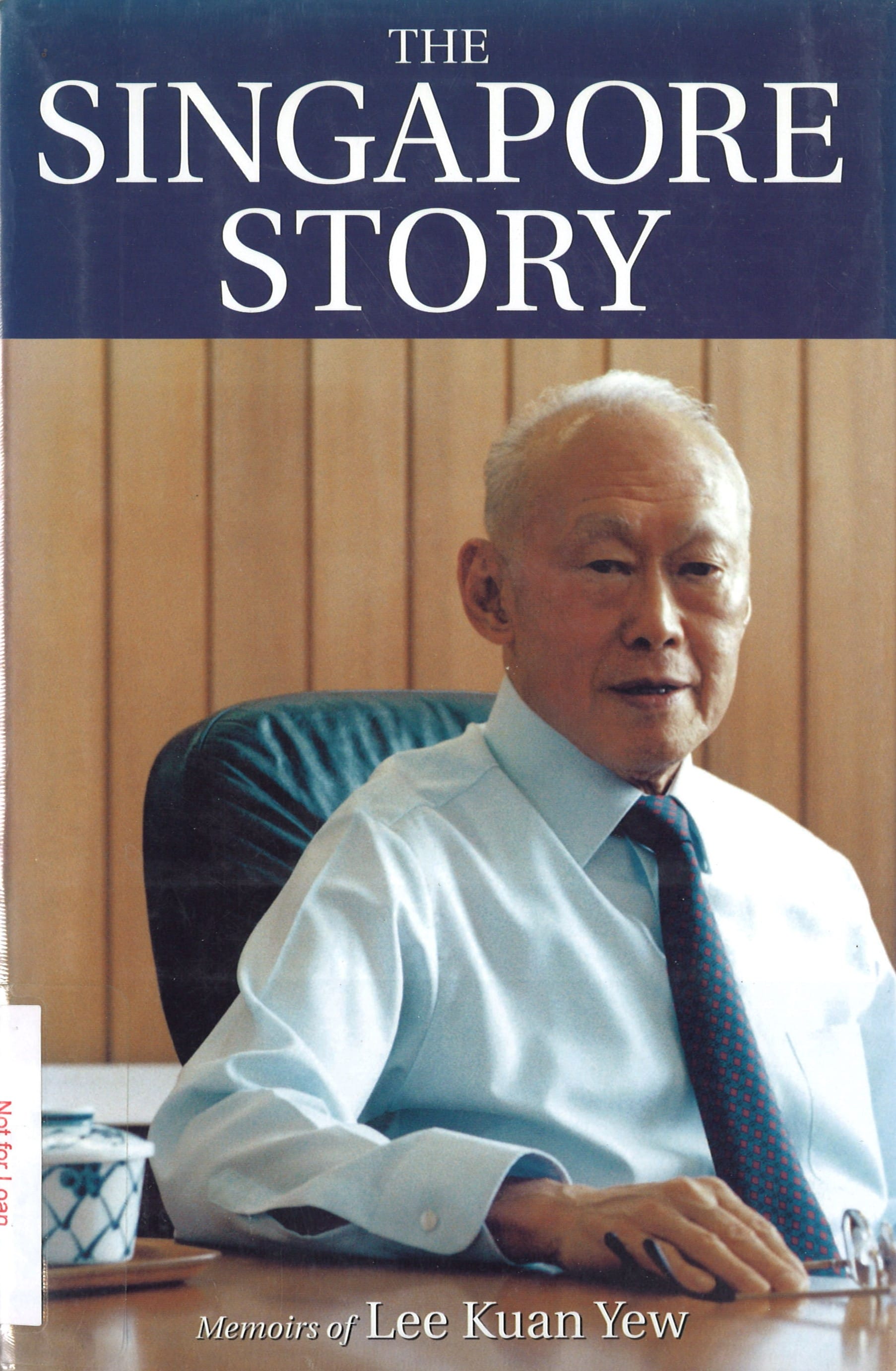 "The Singapore Story" book cover features a portrait of Lee Kuan Yew in a light blue shirt and tie, seated against a wood-paneled background.