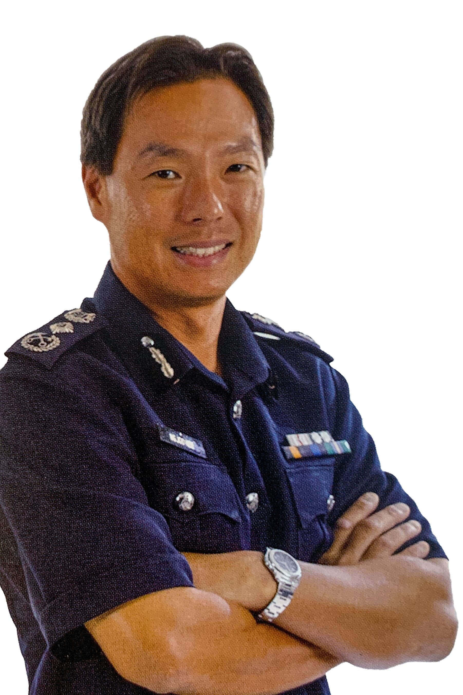 Person wearing a navy blue uniform with badges and medals, arms crossed, and a silver watch on left wrist.