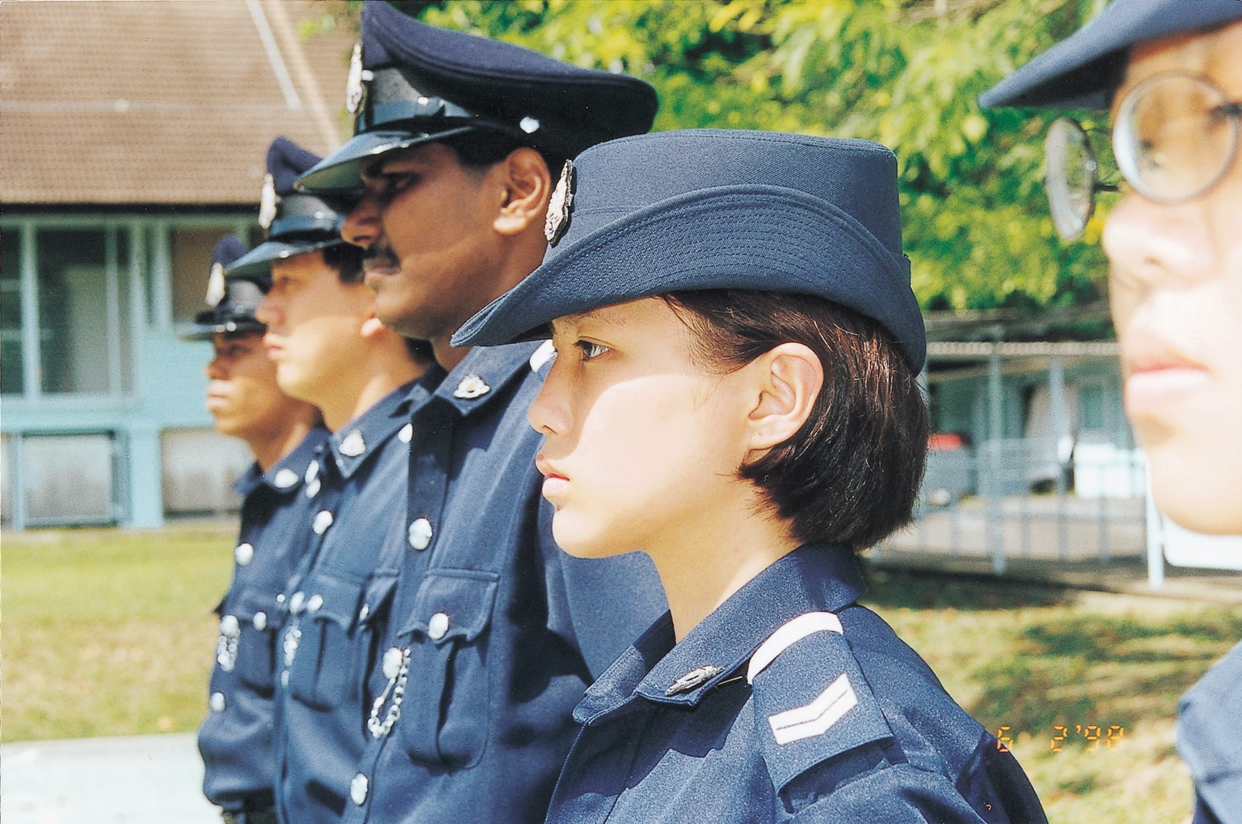 A photograph of officers standing in attention, looking determined and focused.