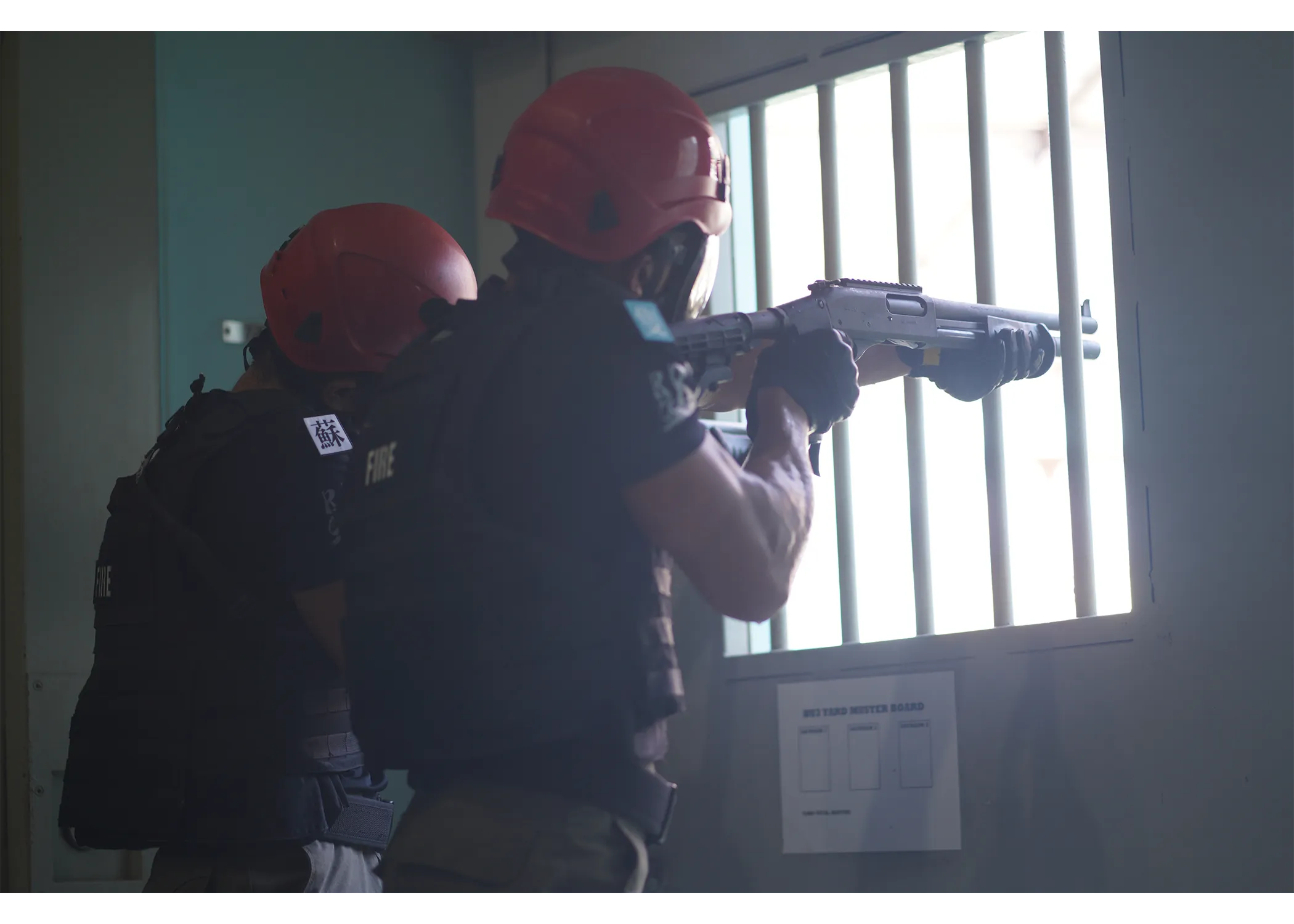 Two officers aiming their rifle through the slider window