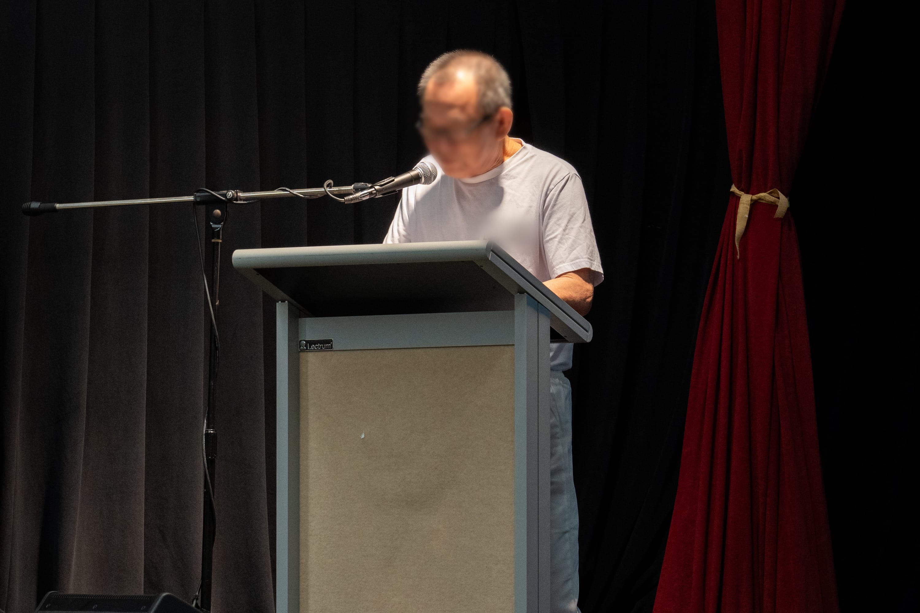 An inmate reading out his commitment on stage during a gang renunciation programme.