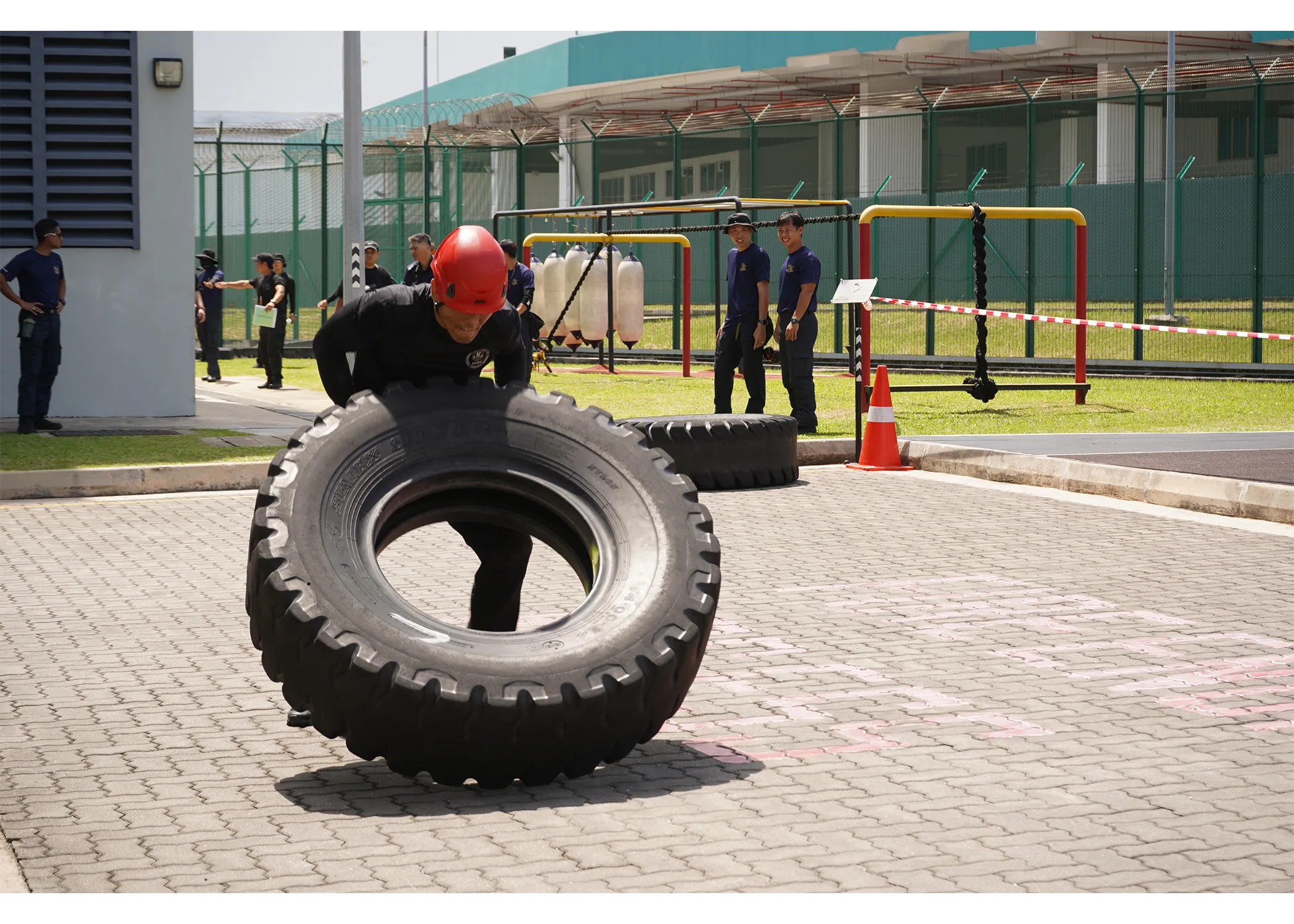 An officer in his attempt of the heavy tyre flip event