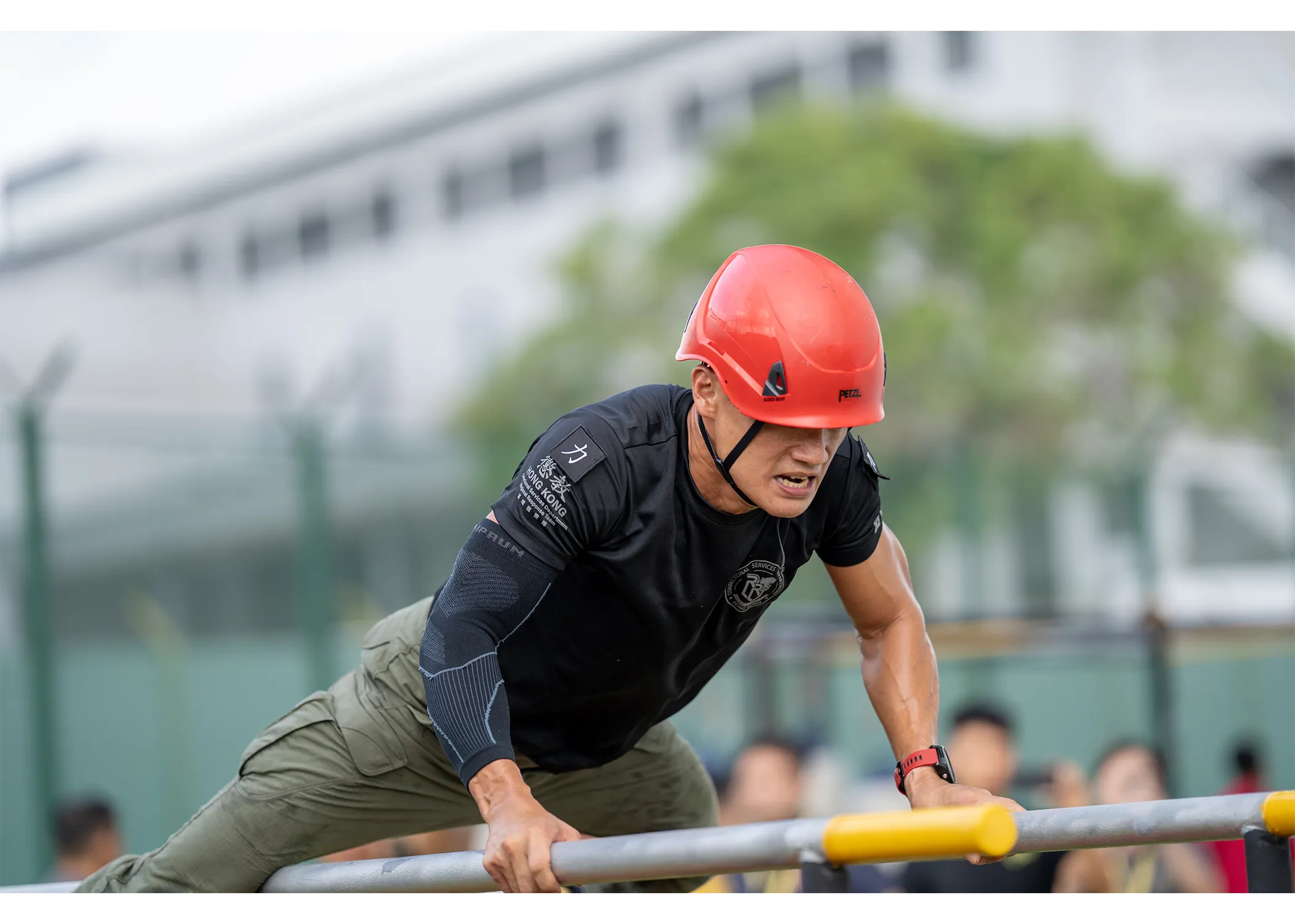 An officer traversing the parallel bar station looking very determined