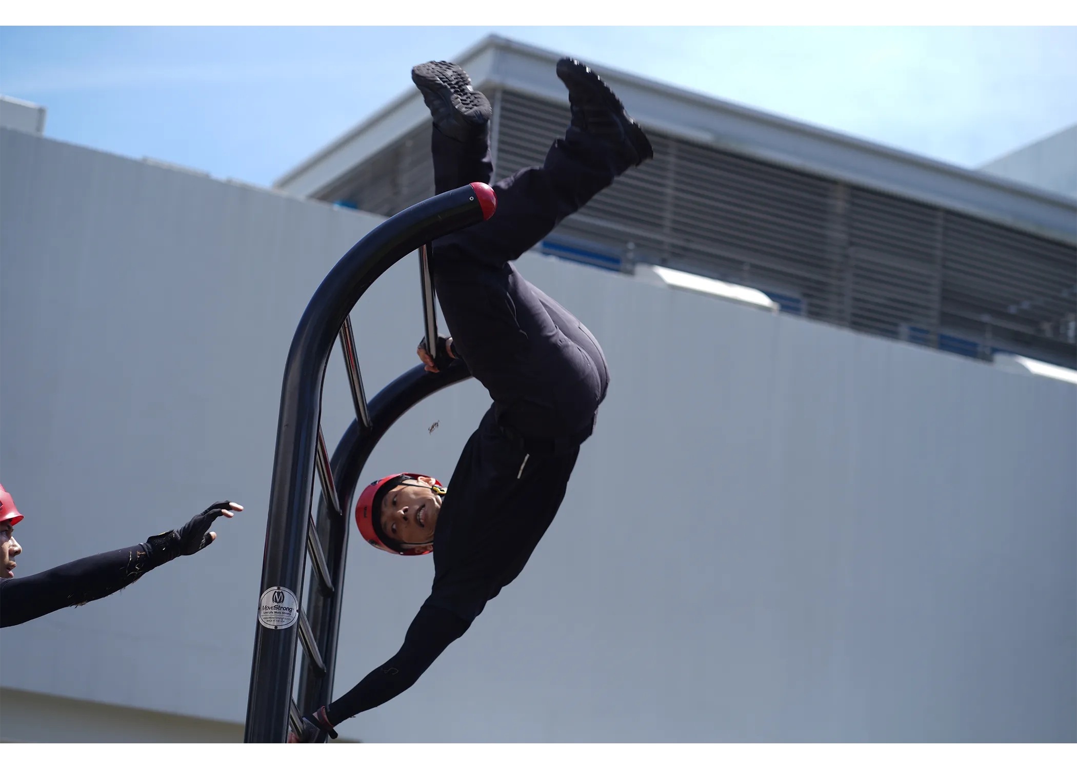 An officer climbing over the Swedish ladder.