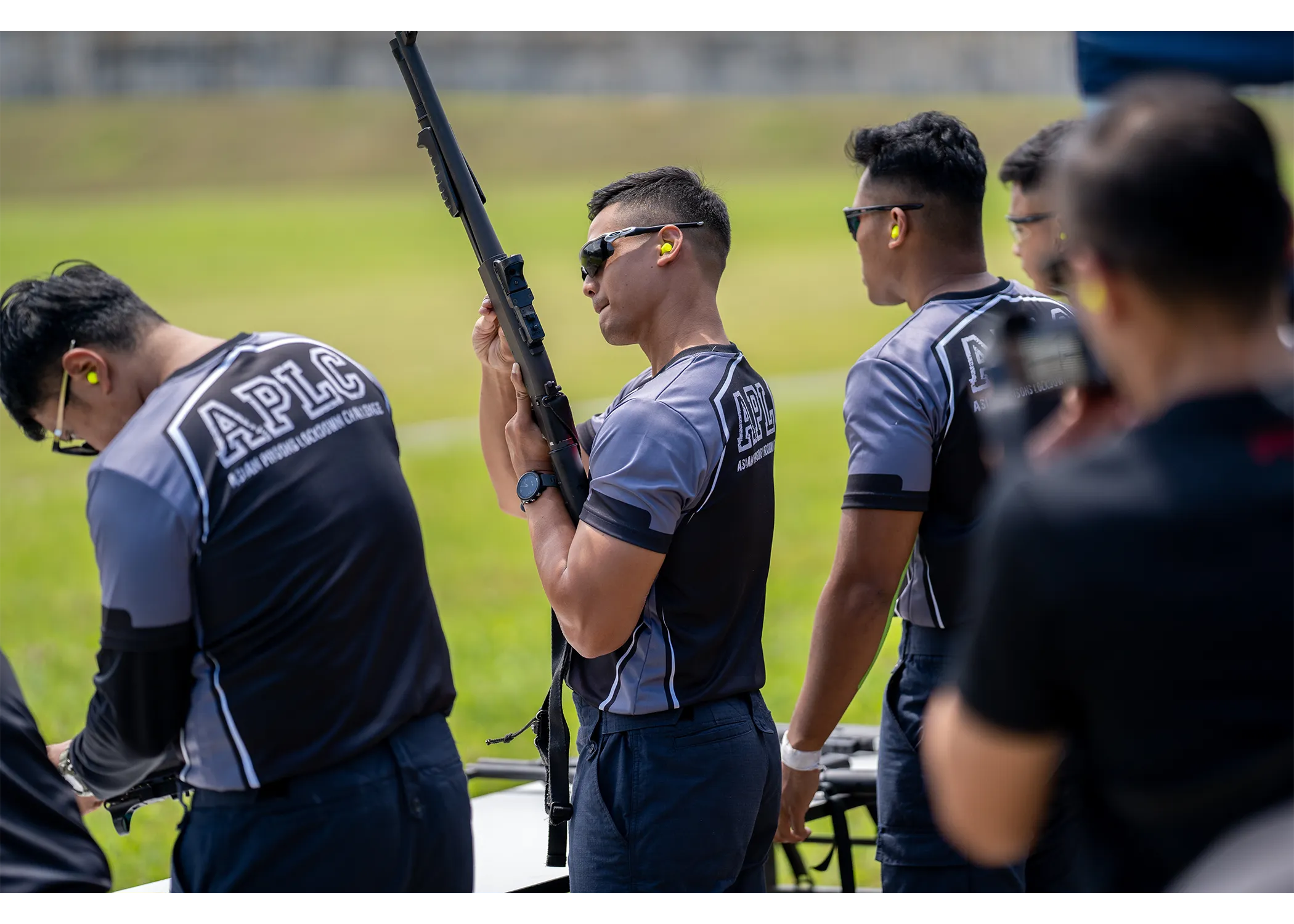 An officer checking his rifle prior to the outdoor shooting event. 