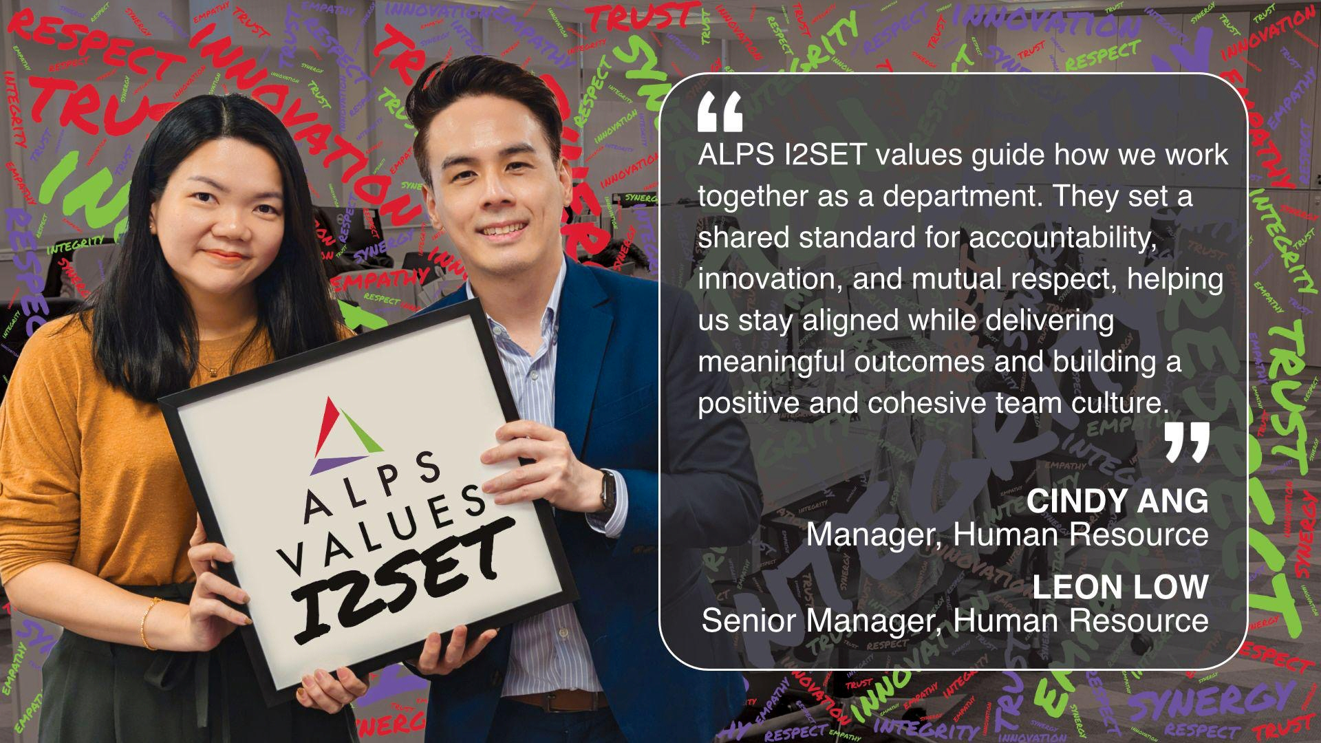 Image of 2 ALPS colleagues holding card displaying words 'ALPS Values I2SET'