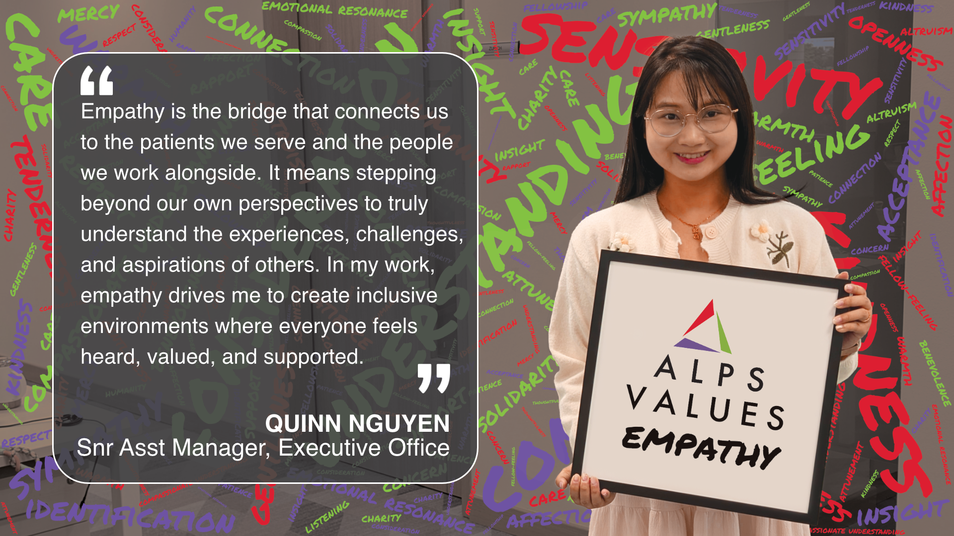 Image of ALPS colleague holding card displaying words 'ALPS Values Empathy'
