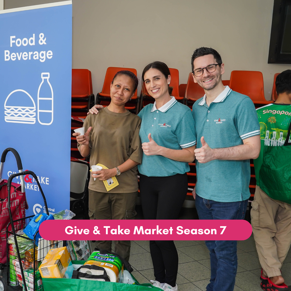 Residents and volunteers pose with donated groceries at Give & Take Market.