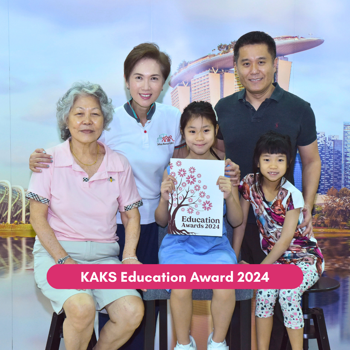 Education award recipient poses with family and community representatives.