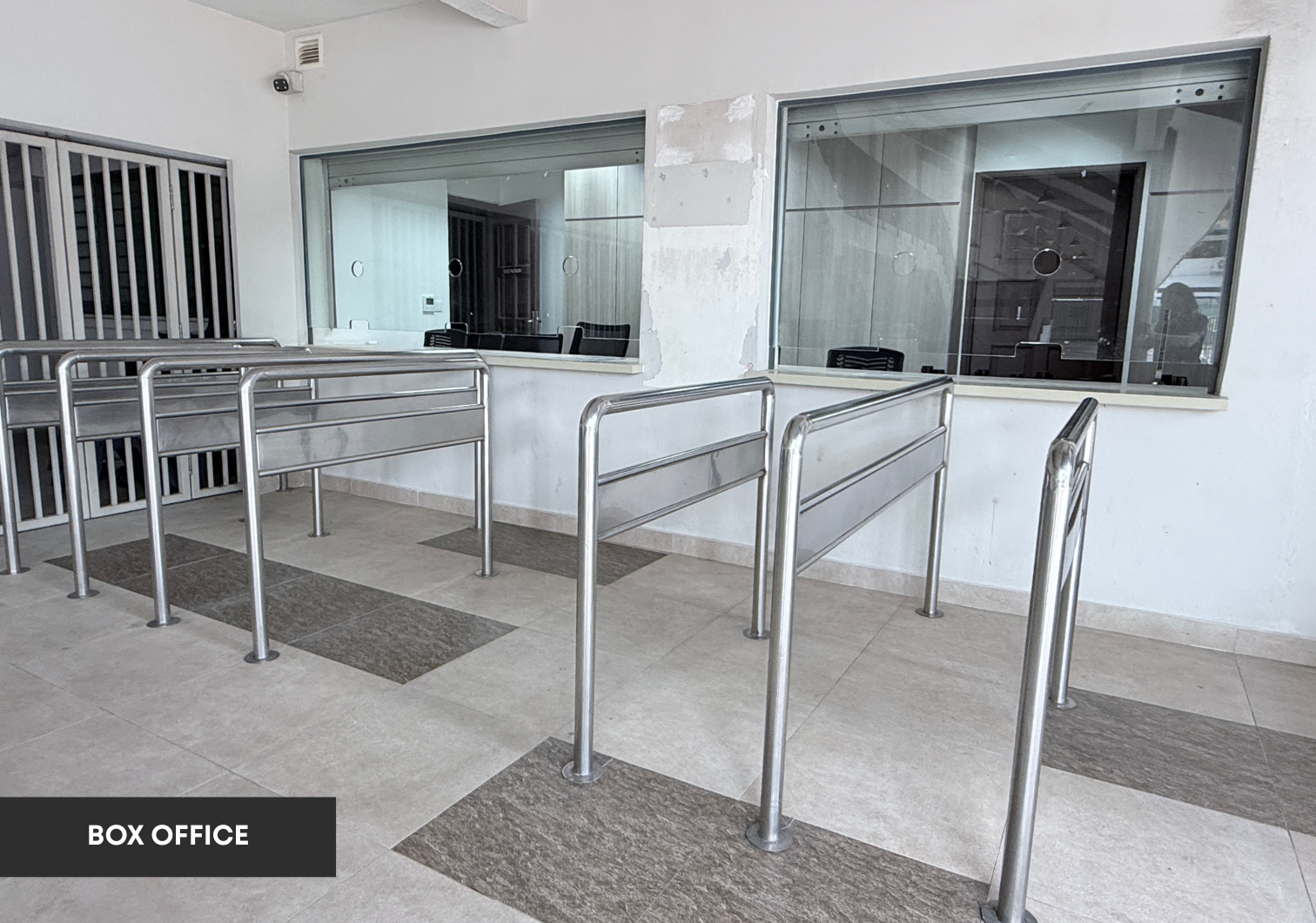 Box office counter with queue railings and ticket windows.