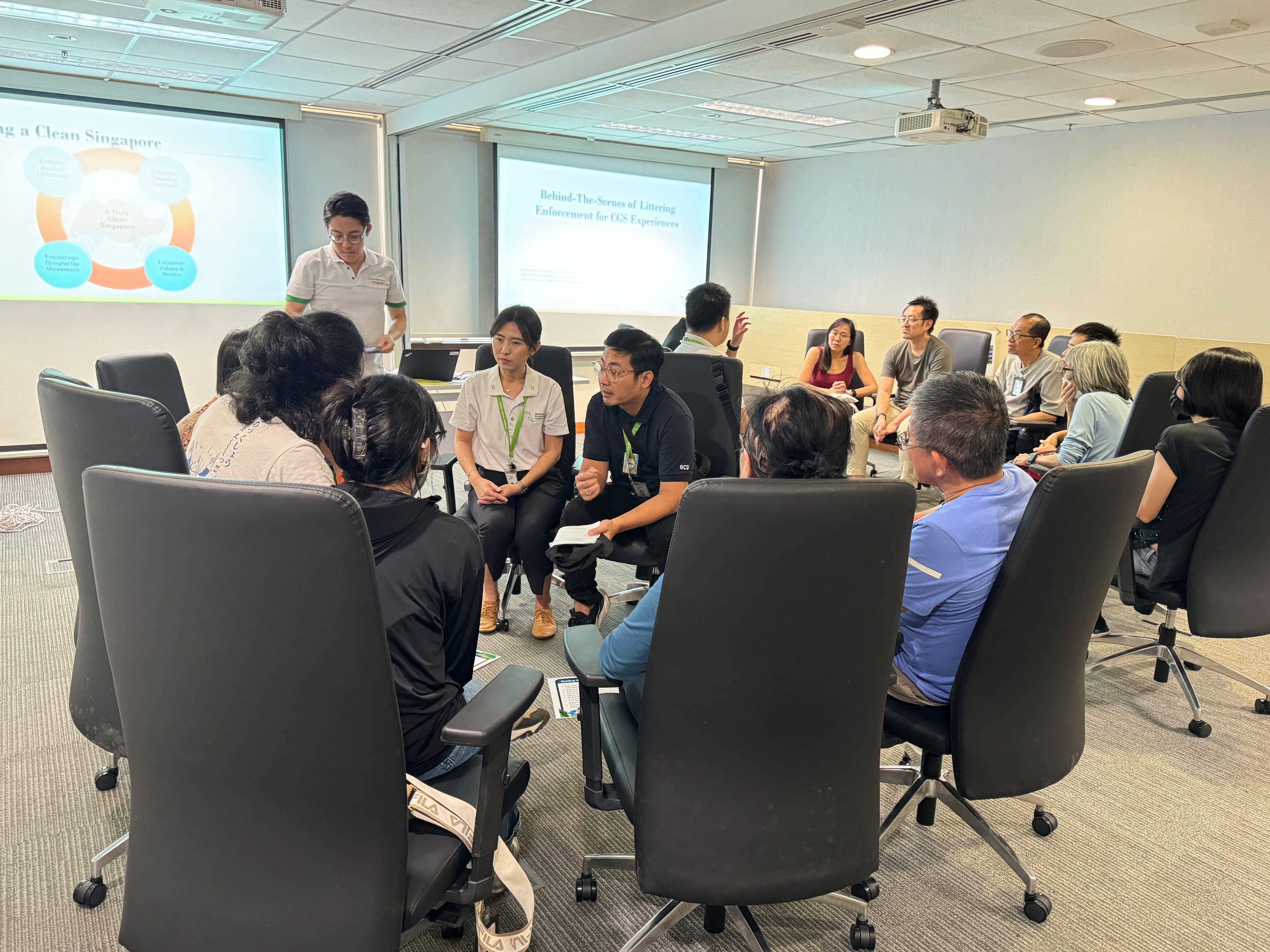 A group of people in a room learning about littering enforcement.