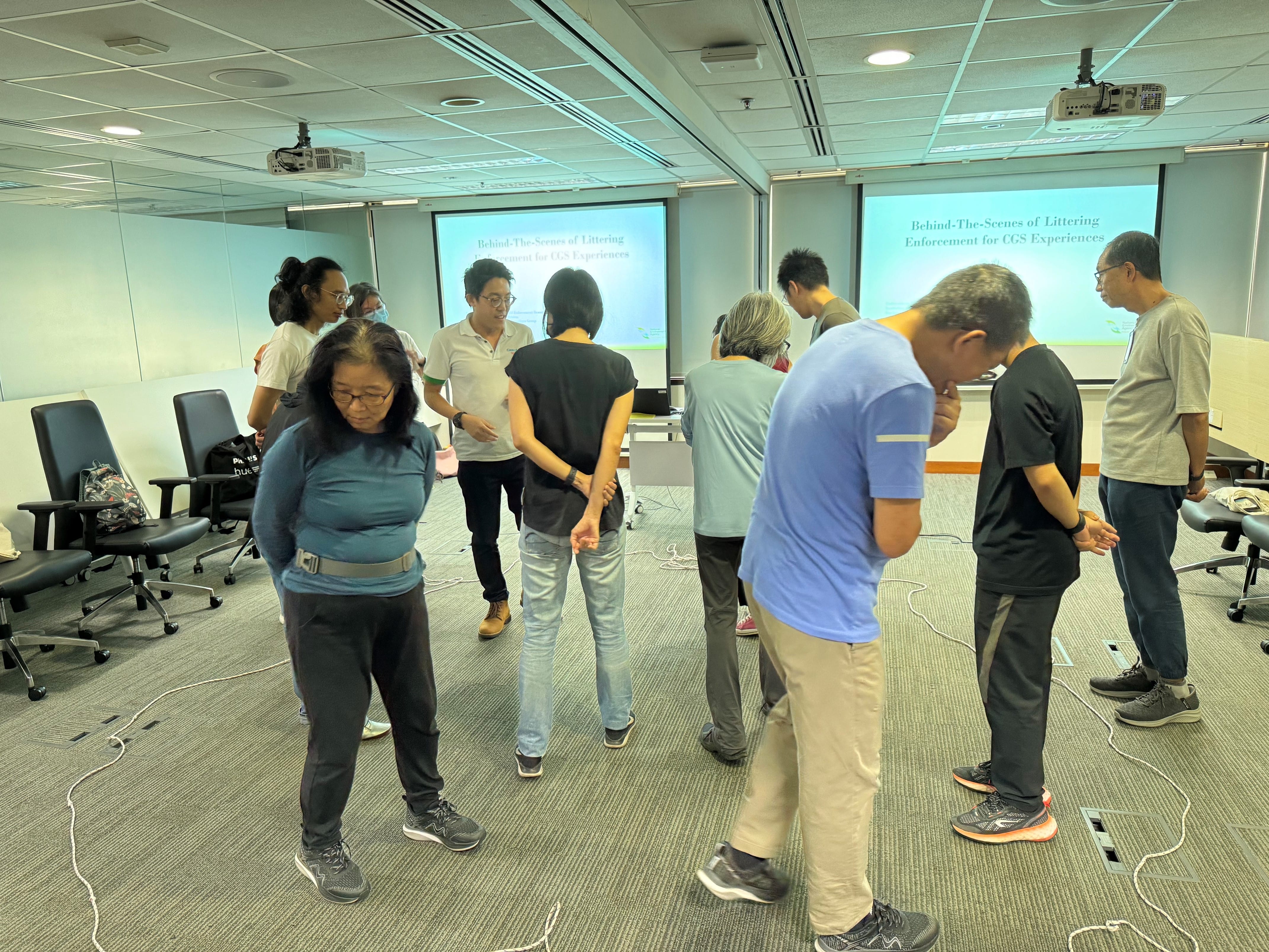 A group of people in a room learning about littering enforcement.