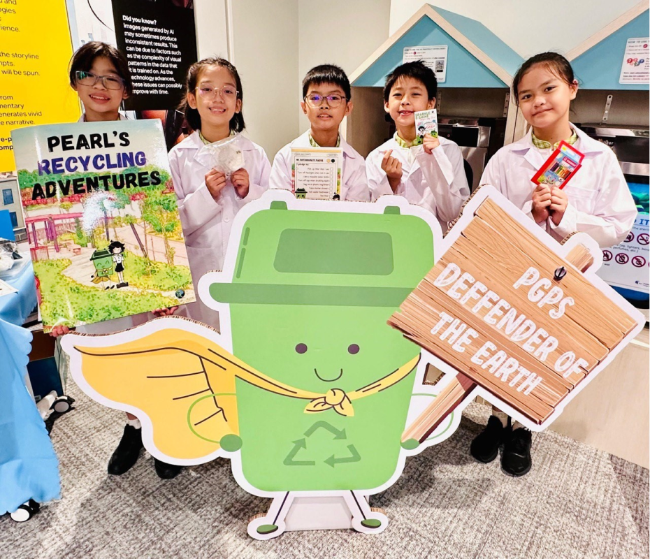 Five children in white lab coats hold recycling-themed signs including Pearl's Recycling Adventures book and PGPS Defender of the Earth.
