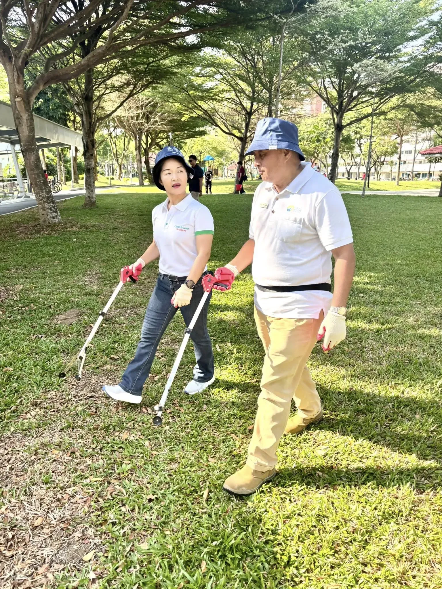 Two people one male one female picking rubbish