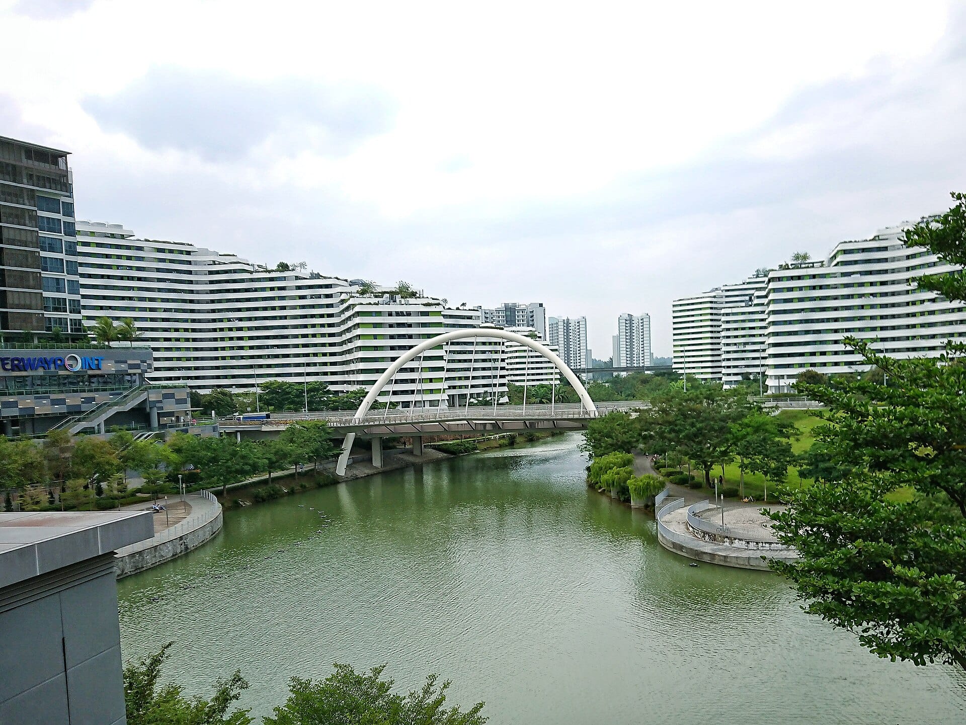A bridge over a waterway with modern buildings in the background and text on the right saying "Punggol" and "Start Your Journey".