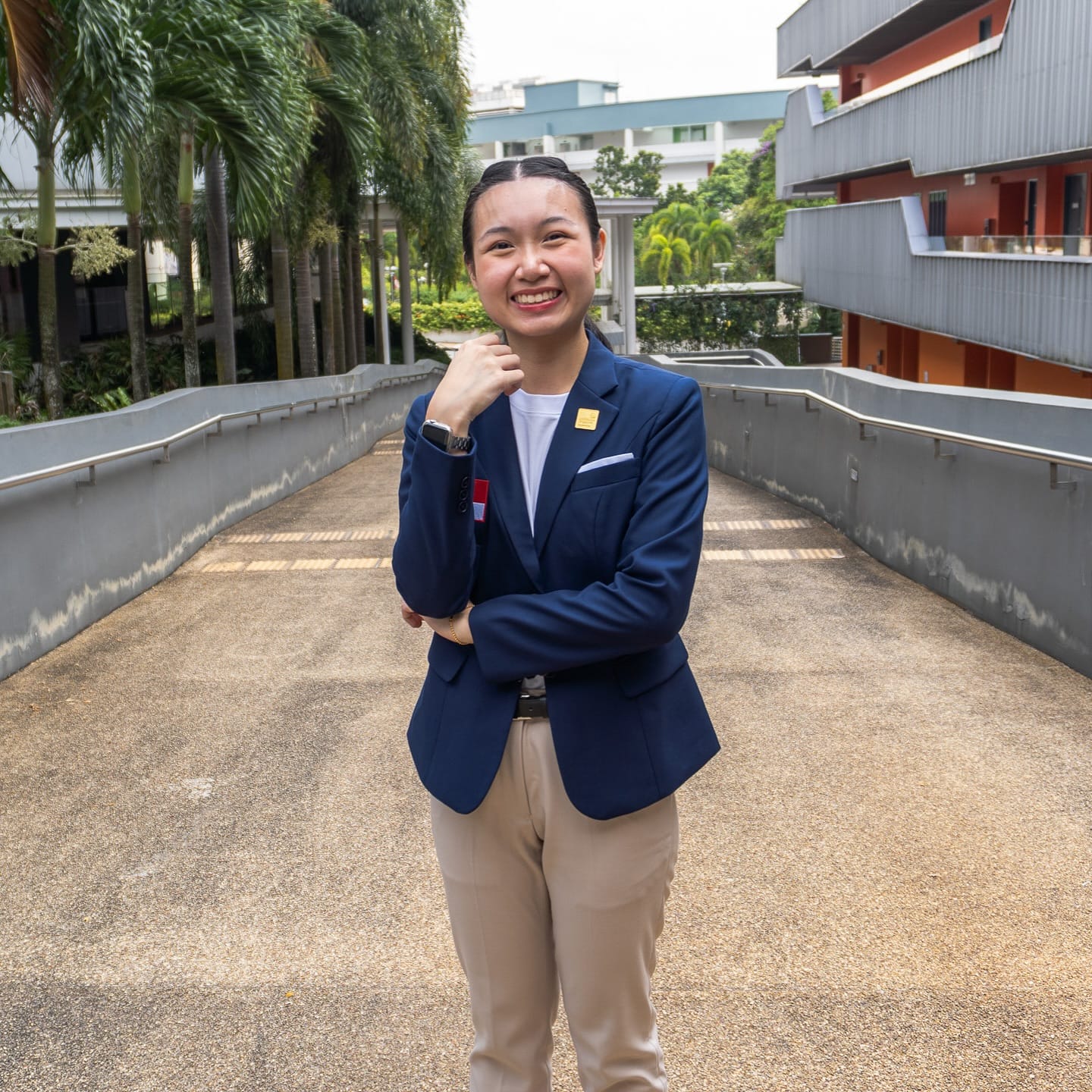 Charmaine Lee Qianyu, Team RP’s Restaurant Service competitor, smiling on campus in a navy blazer.