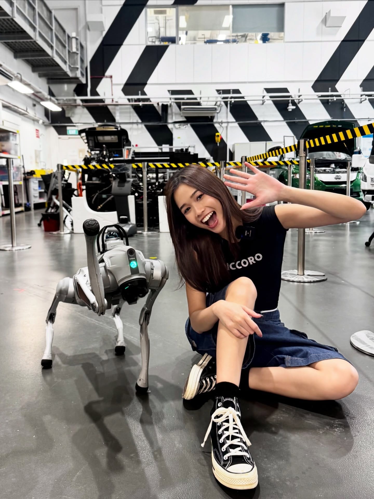 RP alum Dewy Choo posing with a robotic dog in the mobility and robotics lab