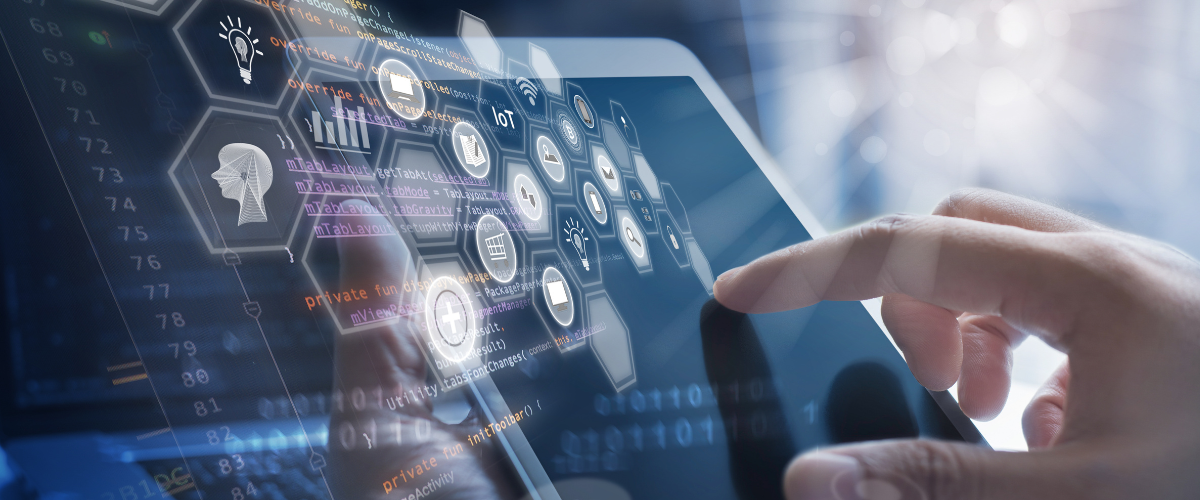 Hand interacting with a tablet displaying digital icons and code overlays, symbolising IoT, app development, and smart technology integration.