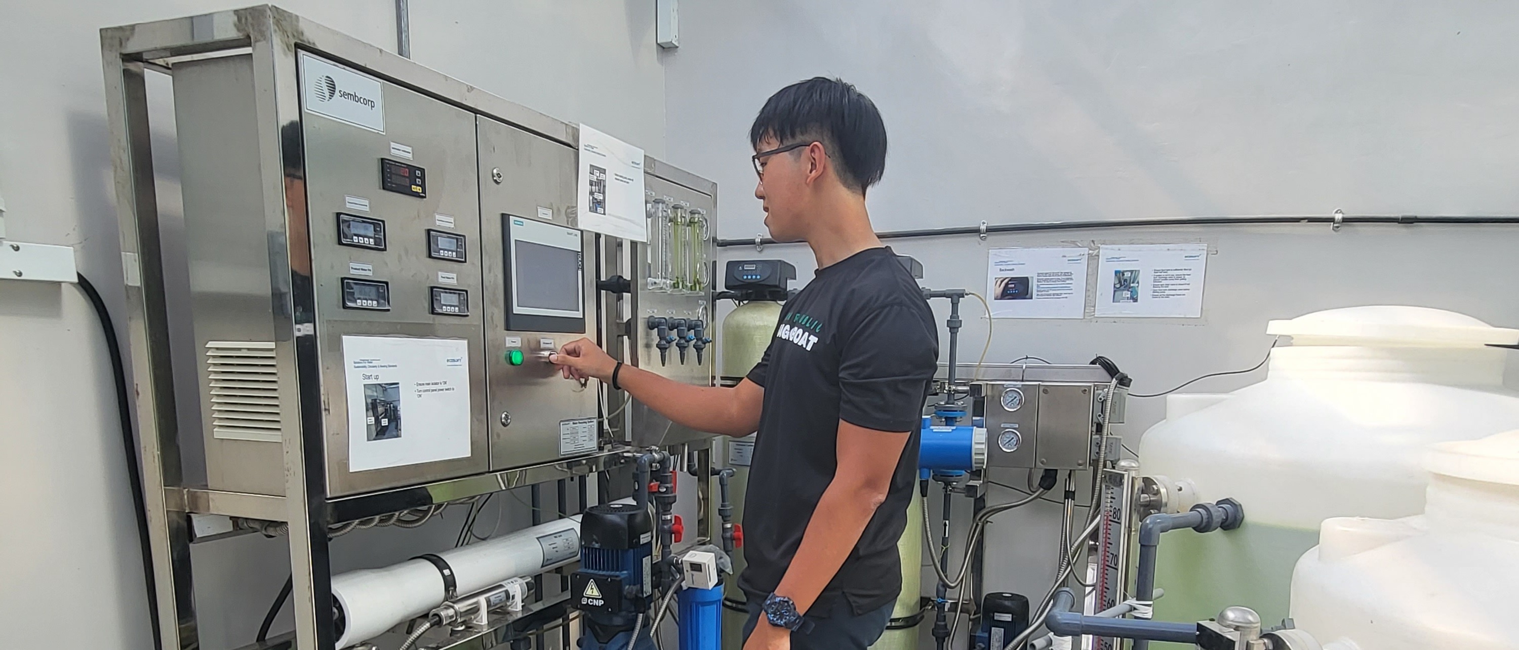 A bespectacled male using a machine