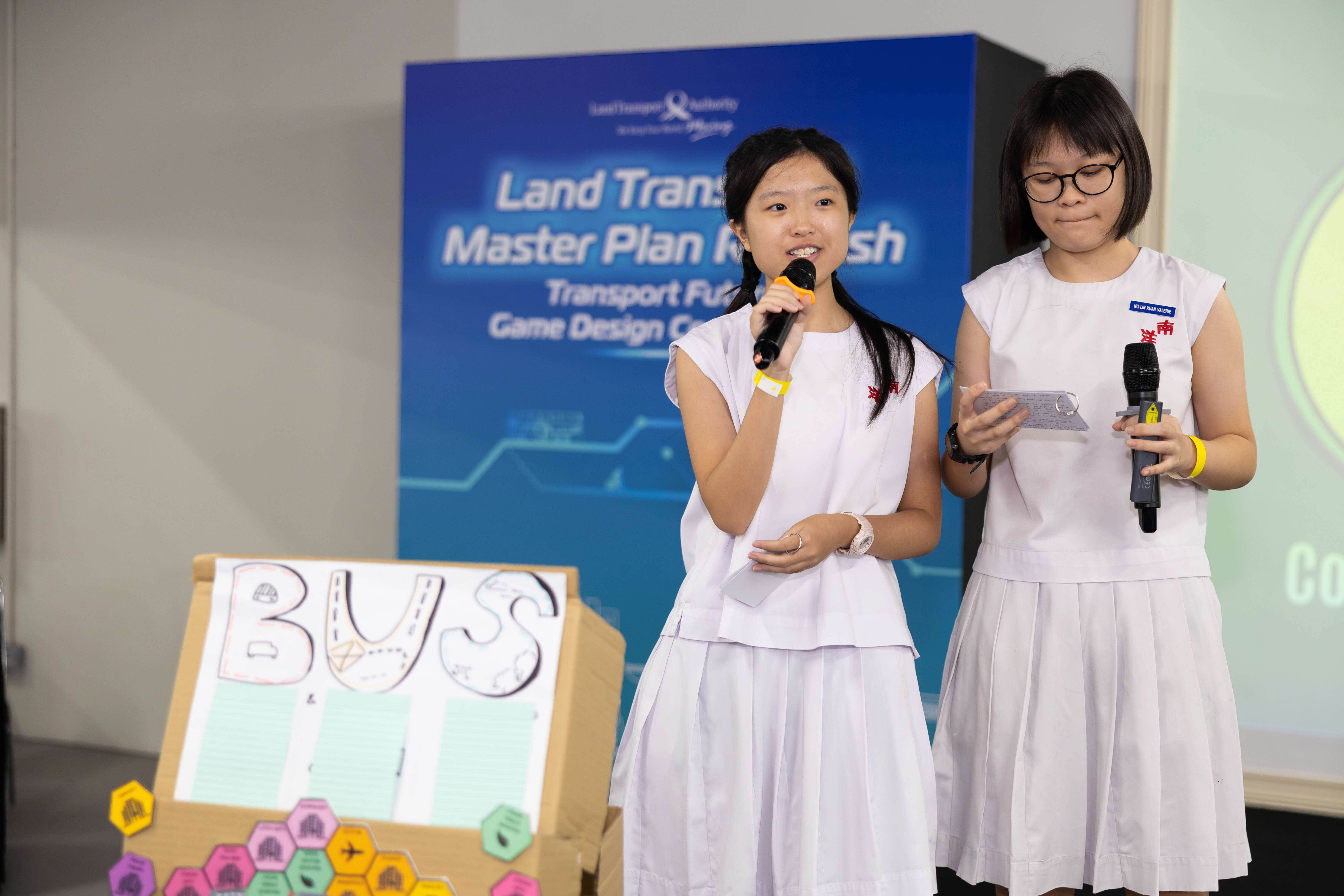 Image of 2 students presenting on stage