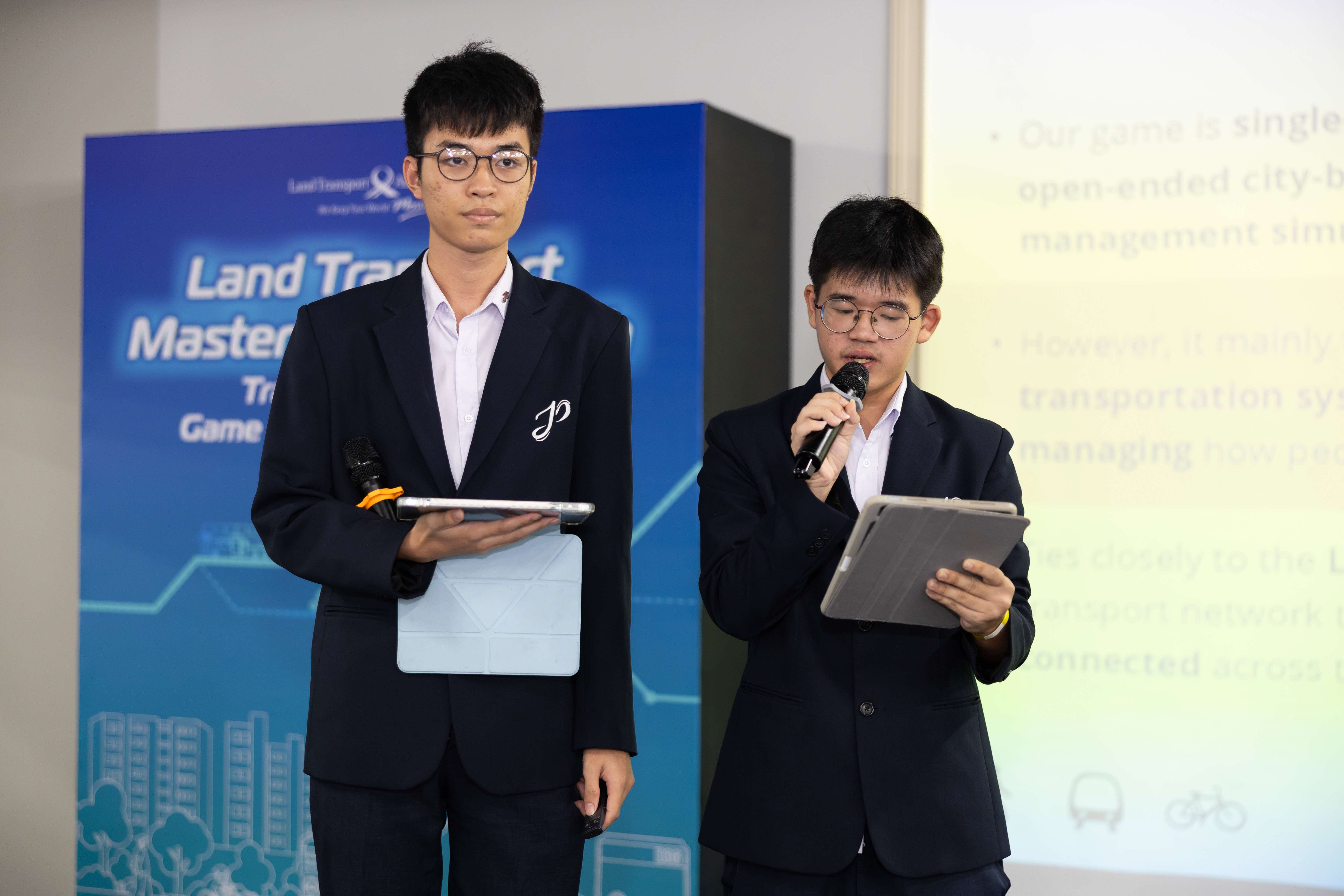 Image of 2 students presenting on stage