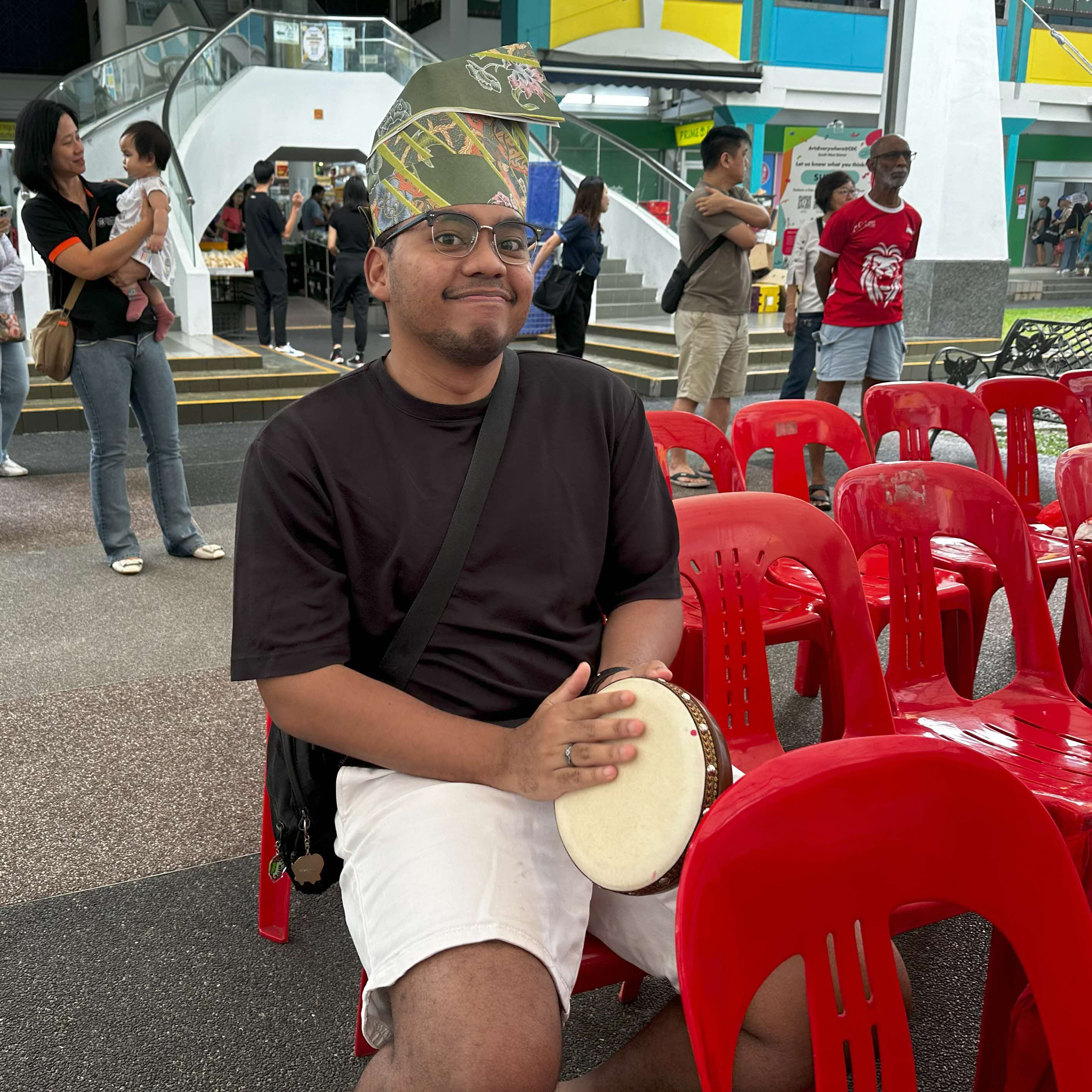 Audience members young and old learning how to play the kompang
