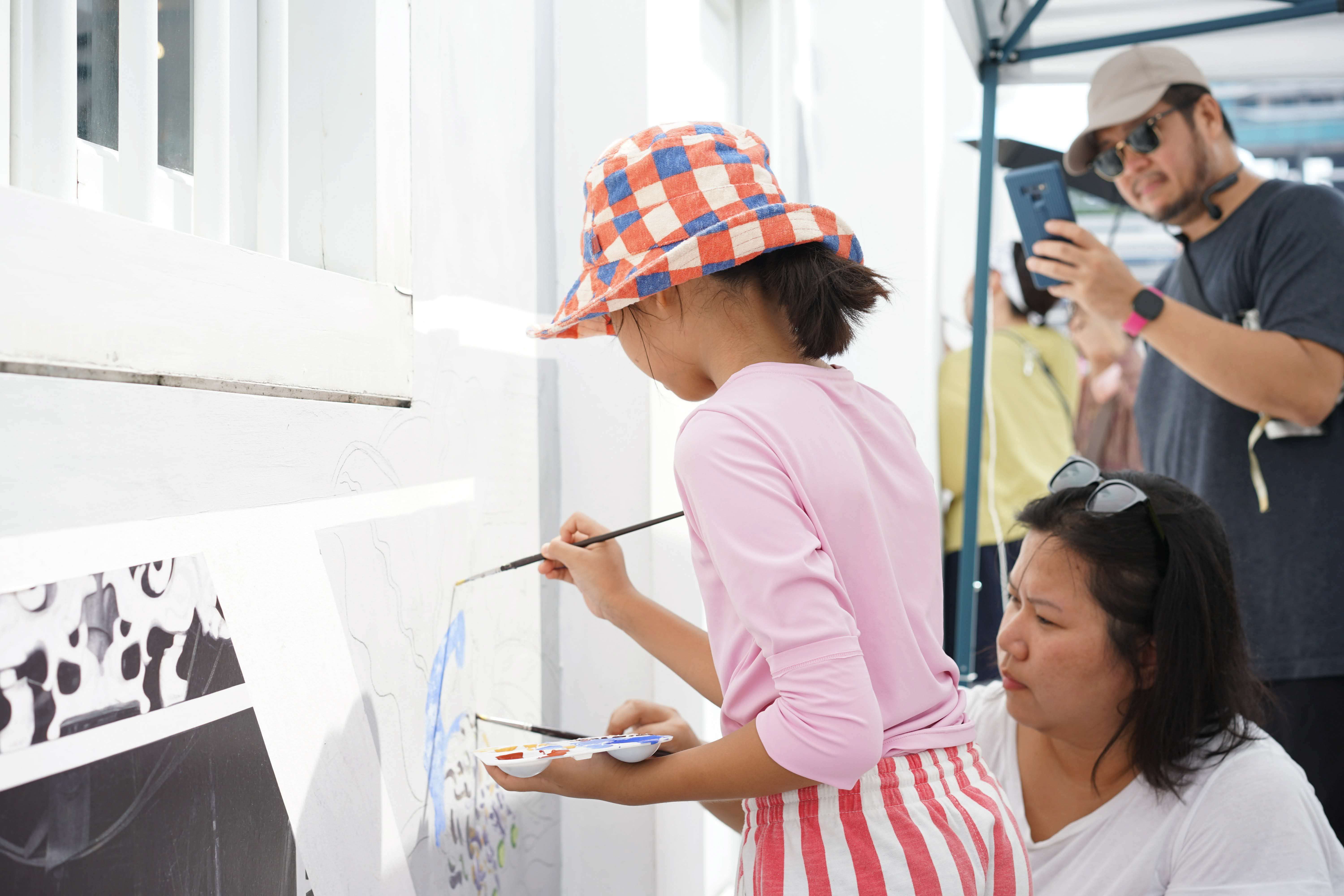 Another behind-the-scenes look at the process of ‘A Particular Place, where contributors work on the wall together.  Photo credit: Singapore Archifest 2023 Curatorial Team.