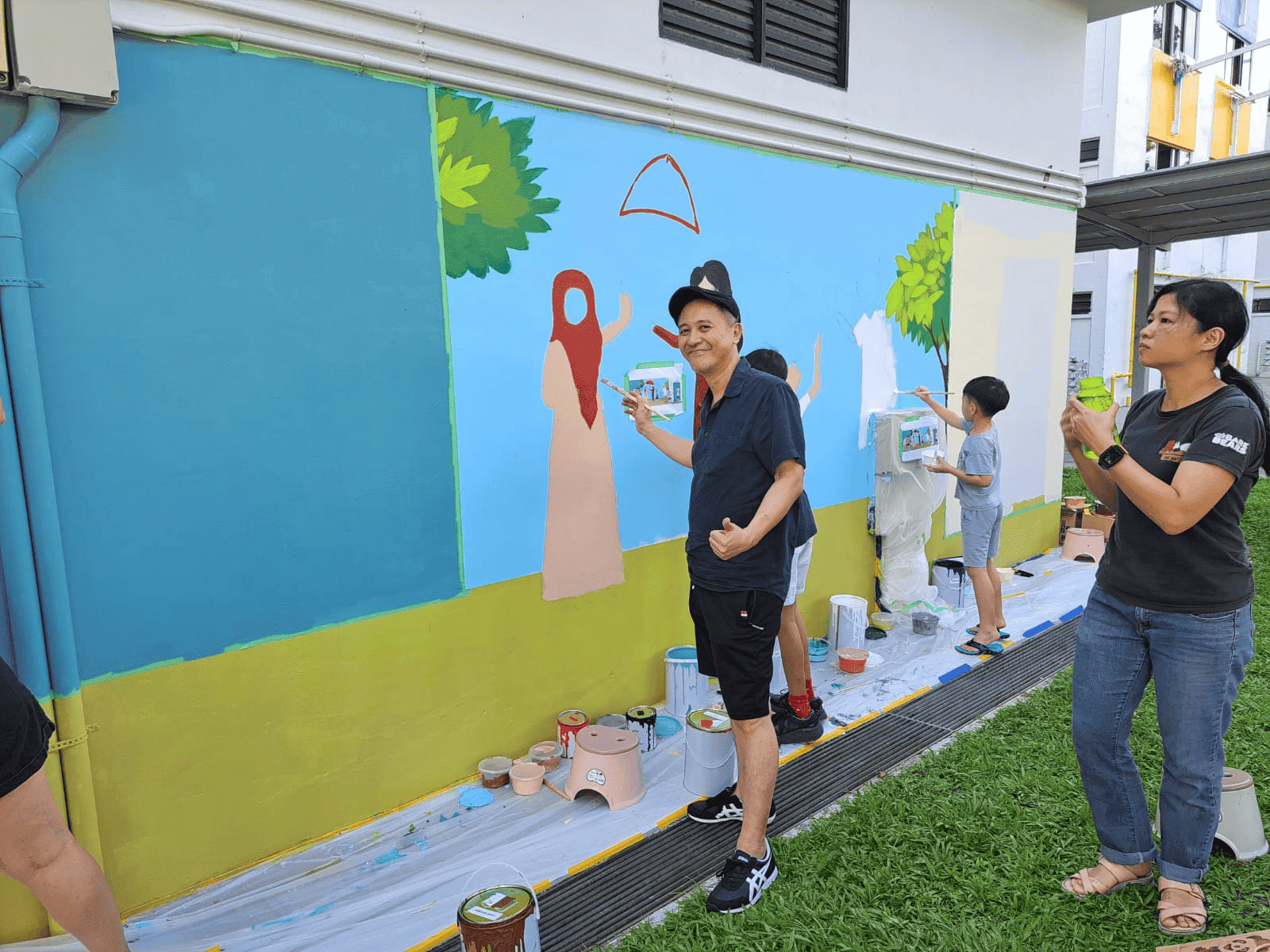 A behind-the-scenes look at the process of ‘Cats & Kindness’, where contributors from all walks of life work on the wall together , Image Credit: Clarence Ho