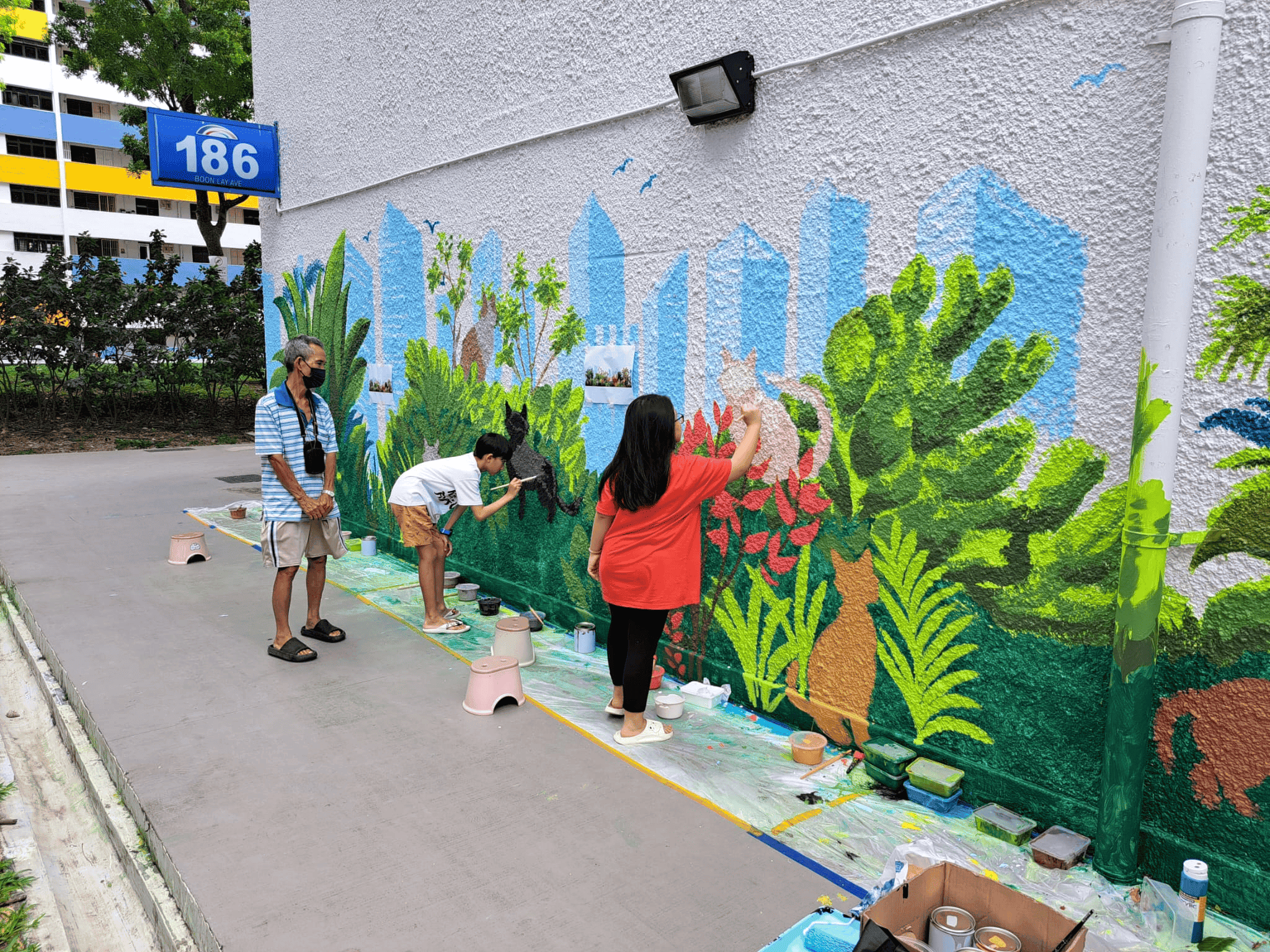 Volunteers working on different parts of the mural Image credit: Clarence Ho