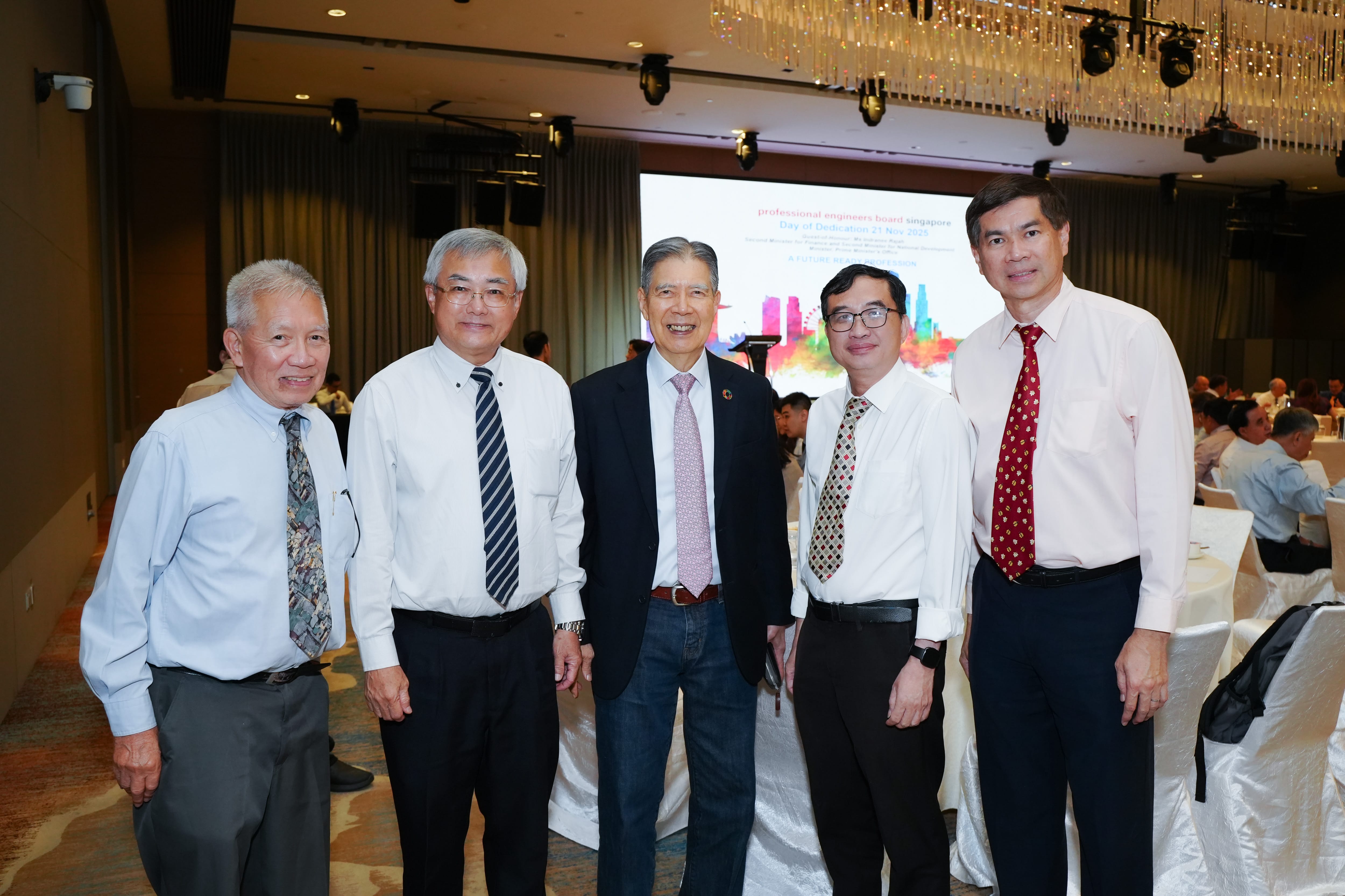 Five men in dress shirts and ties pose together at a Professional Engineers Board Singapore Day of Dedication event.