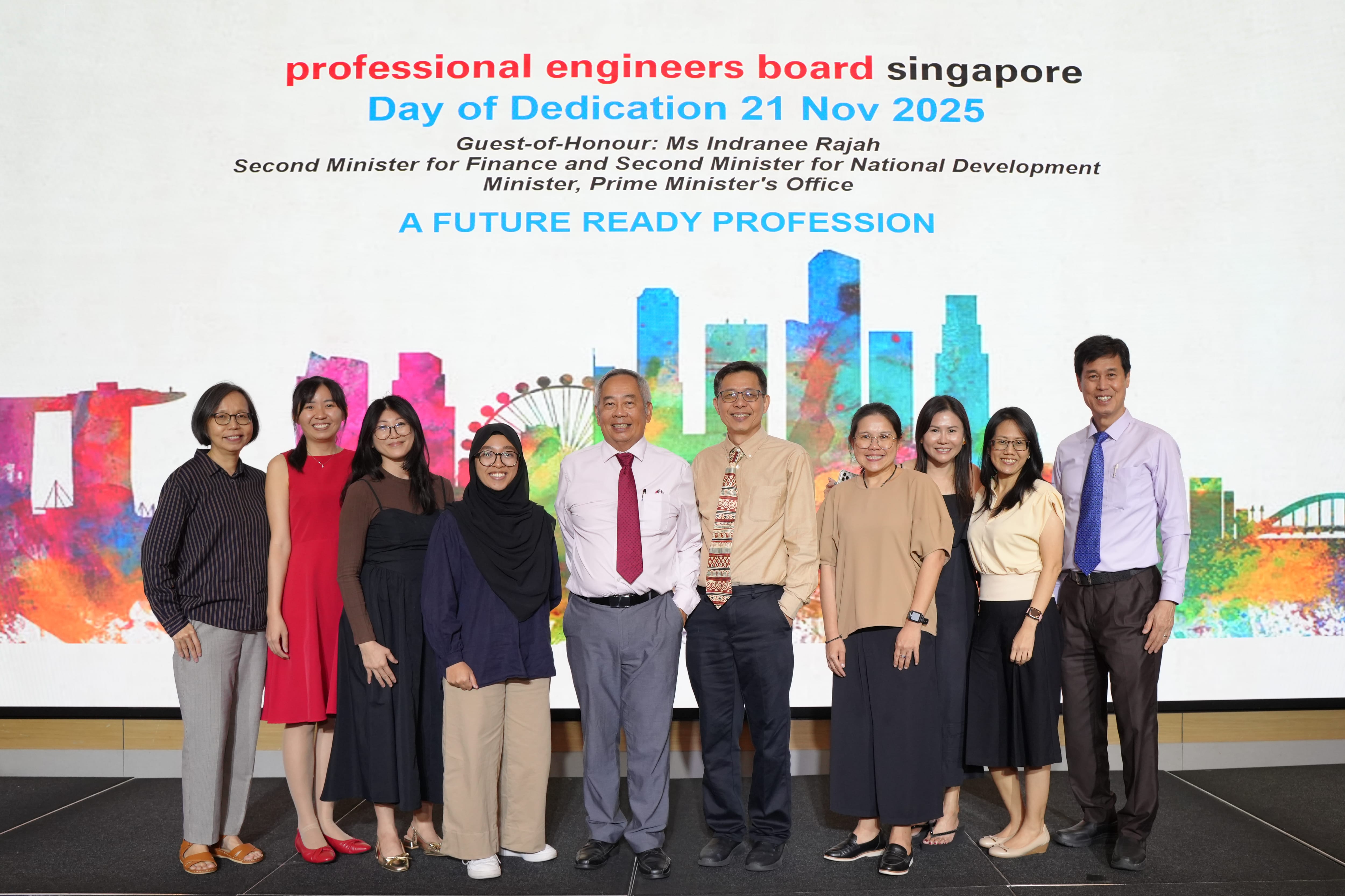 Ten people pose in front of a Professional Engineers Board Singapore Day of Dedication 21 Nov 2025 banner.