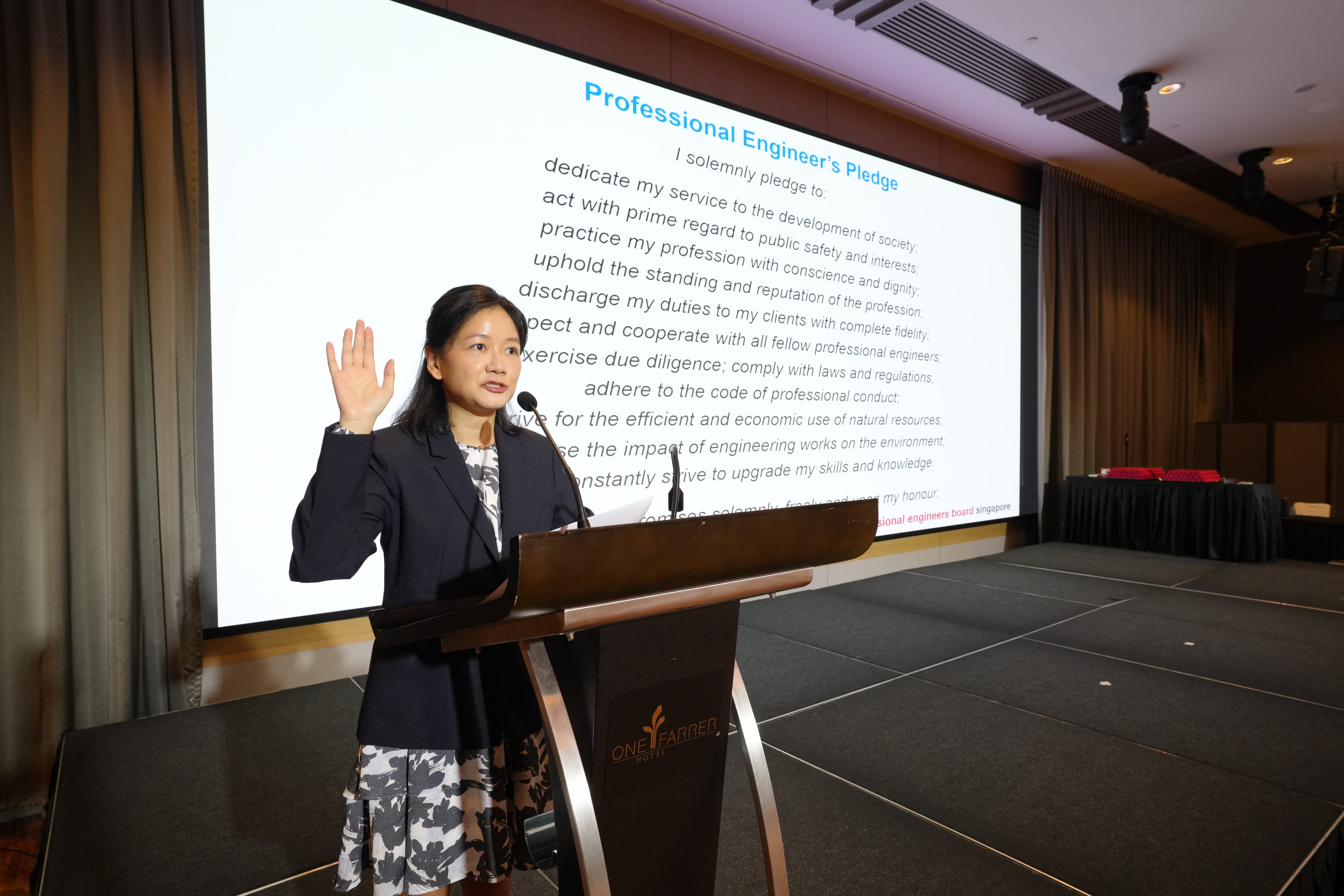 Jasmine Tan, PE (Mechanical), leading the pledge of dedication.