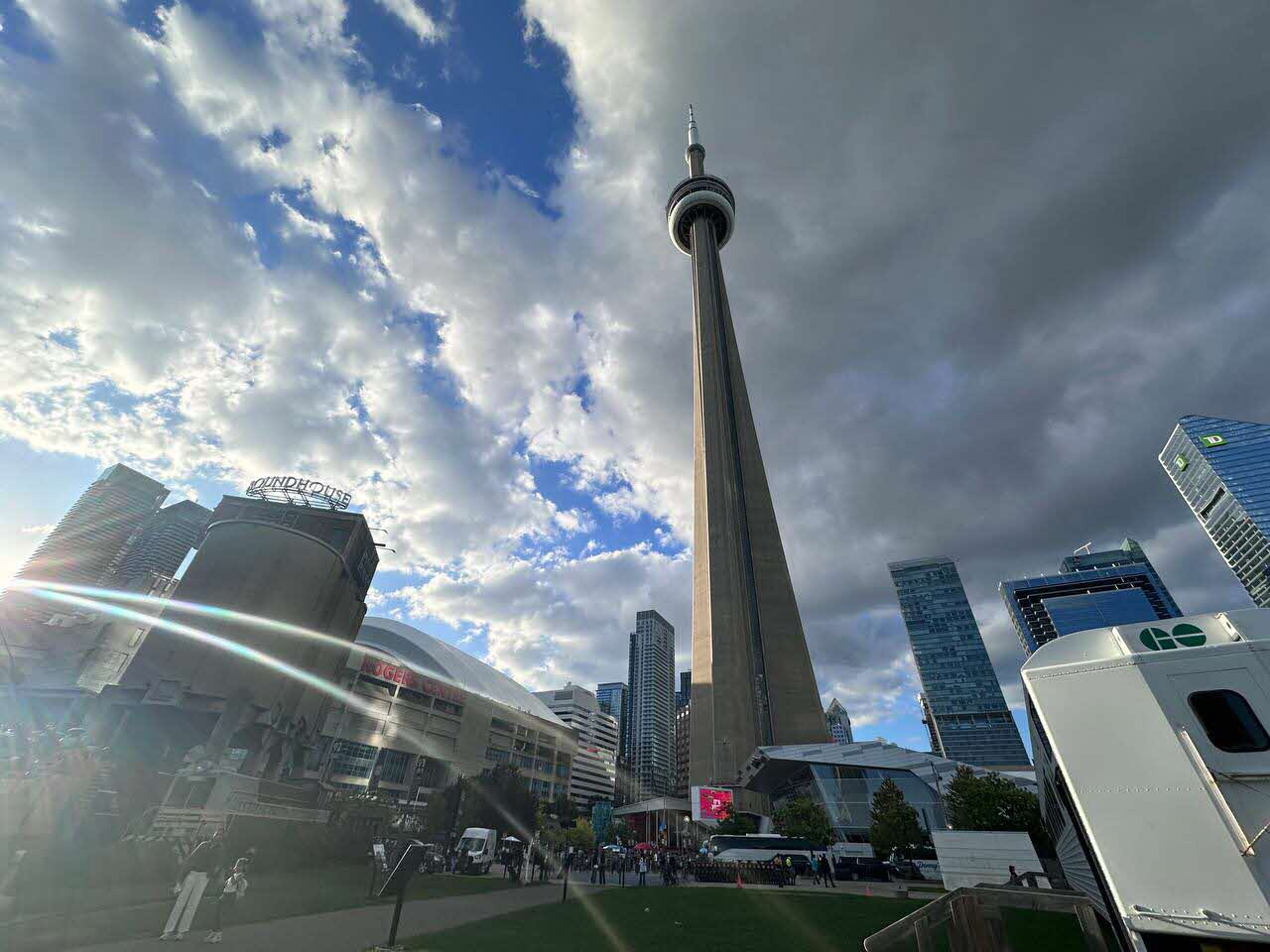 The CN Tower rising above downtown Toronto on a partly cloudy day