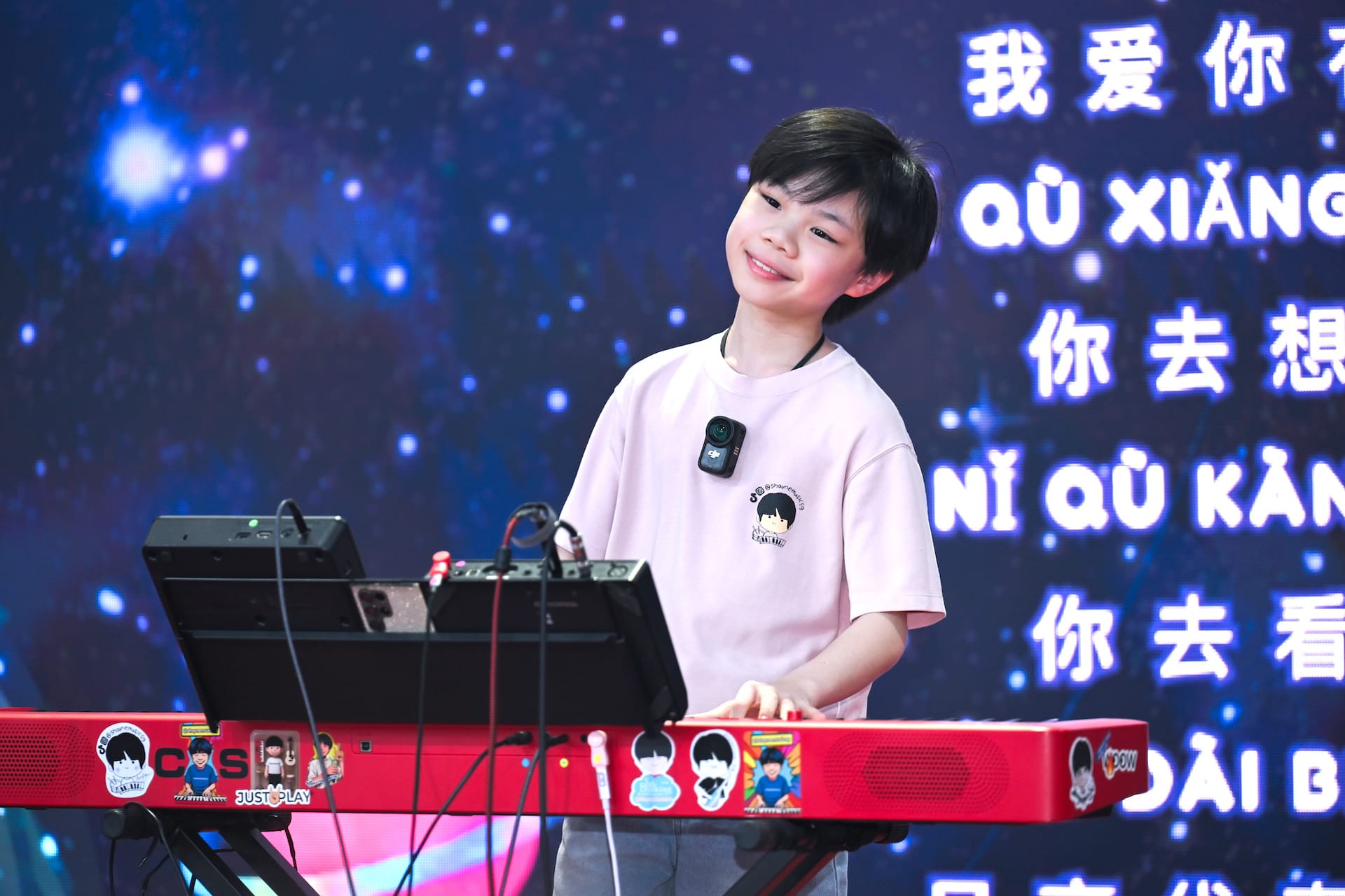 Young artist singing and playing the piano on stage