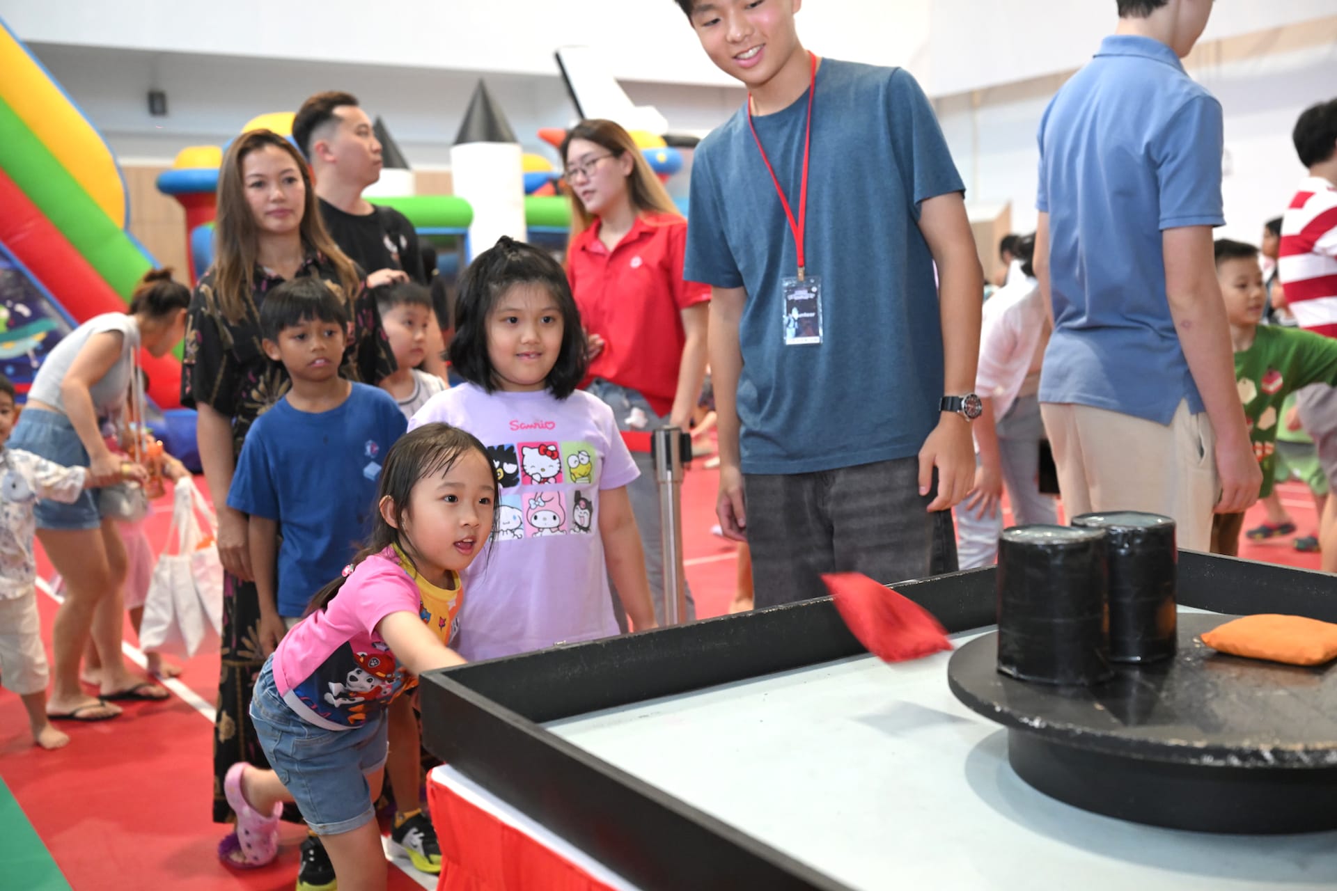 Girl playing carnival tossing game.