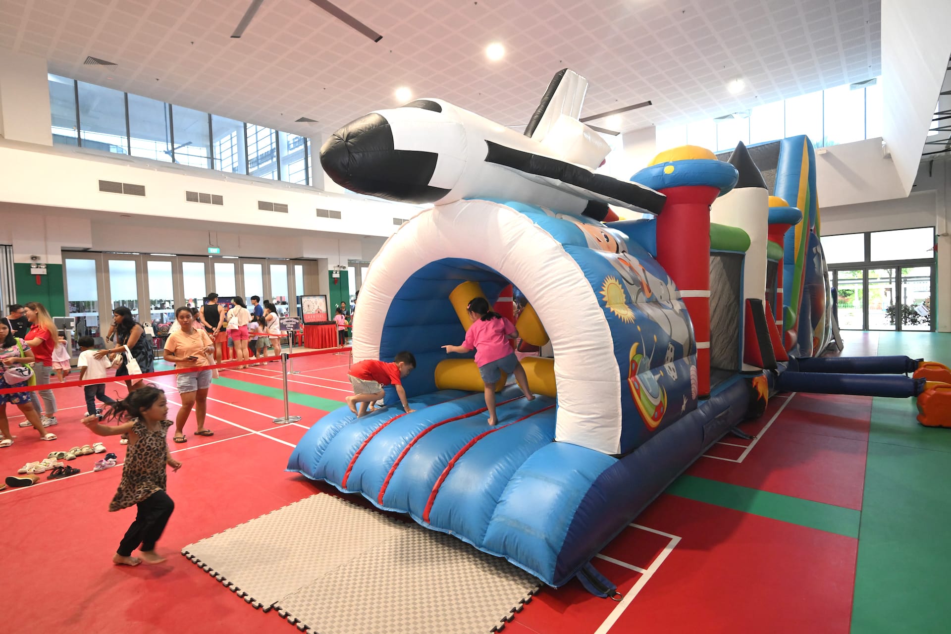 Kids playing at the space-themed bouncy castle