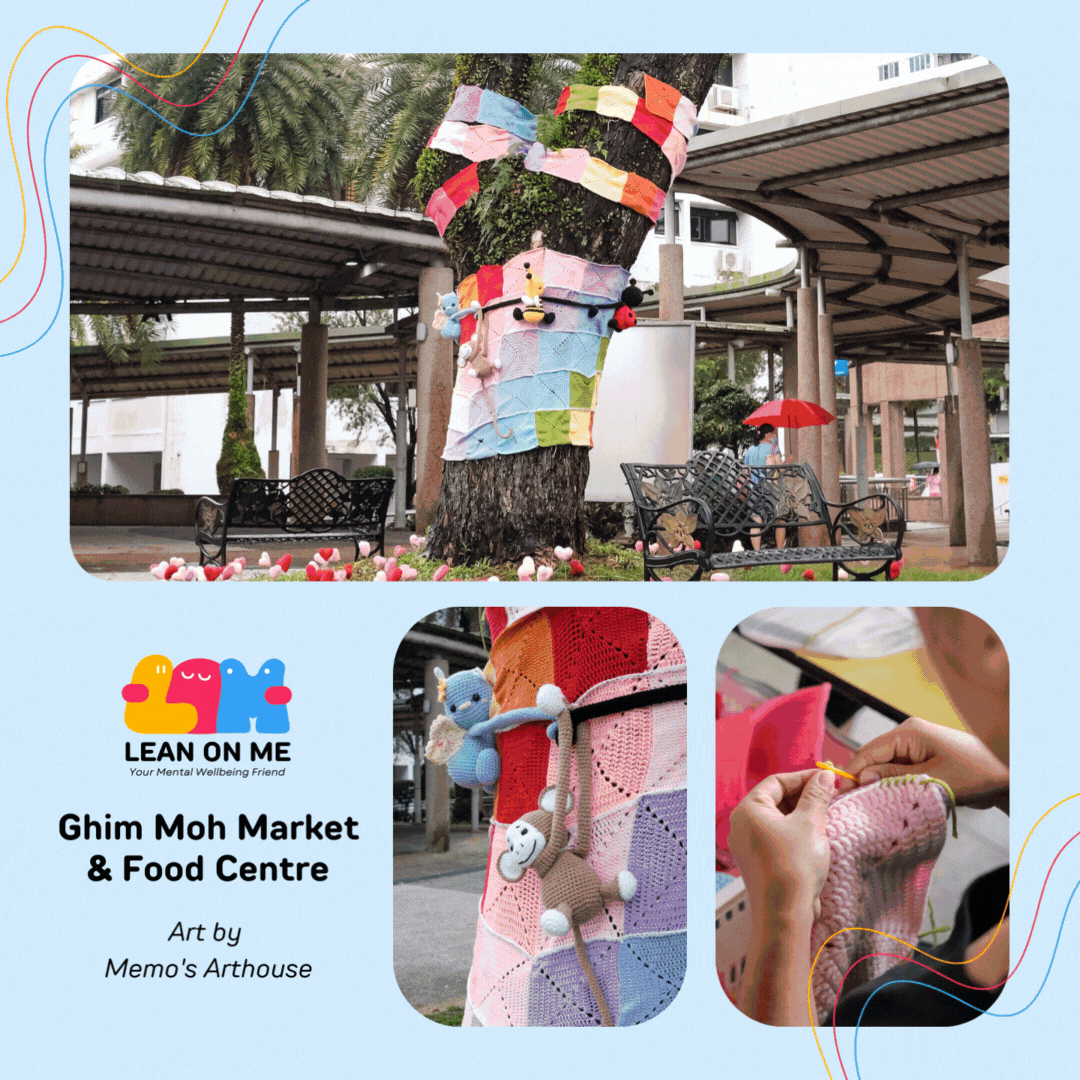 A tree wrapped in colourful crocheted patchwork with cute amigurumi figures at Ghim Moh Market & Food Centre, part of Lean On Me's yarnbombing installation by Memo's Arthouse.