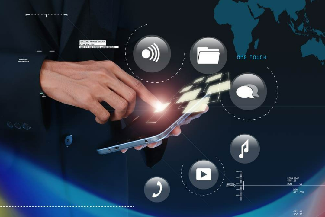 A person in a suit tapping a smartphone with glowing digital app icons floating above it on a dark background.