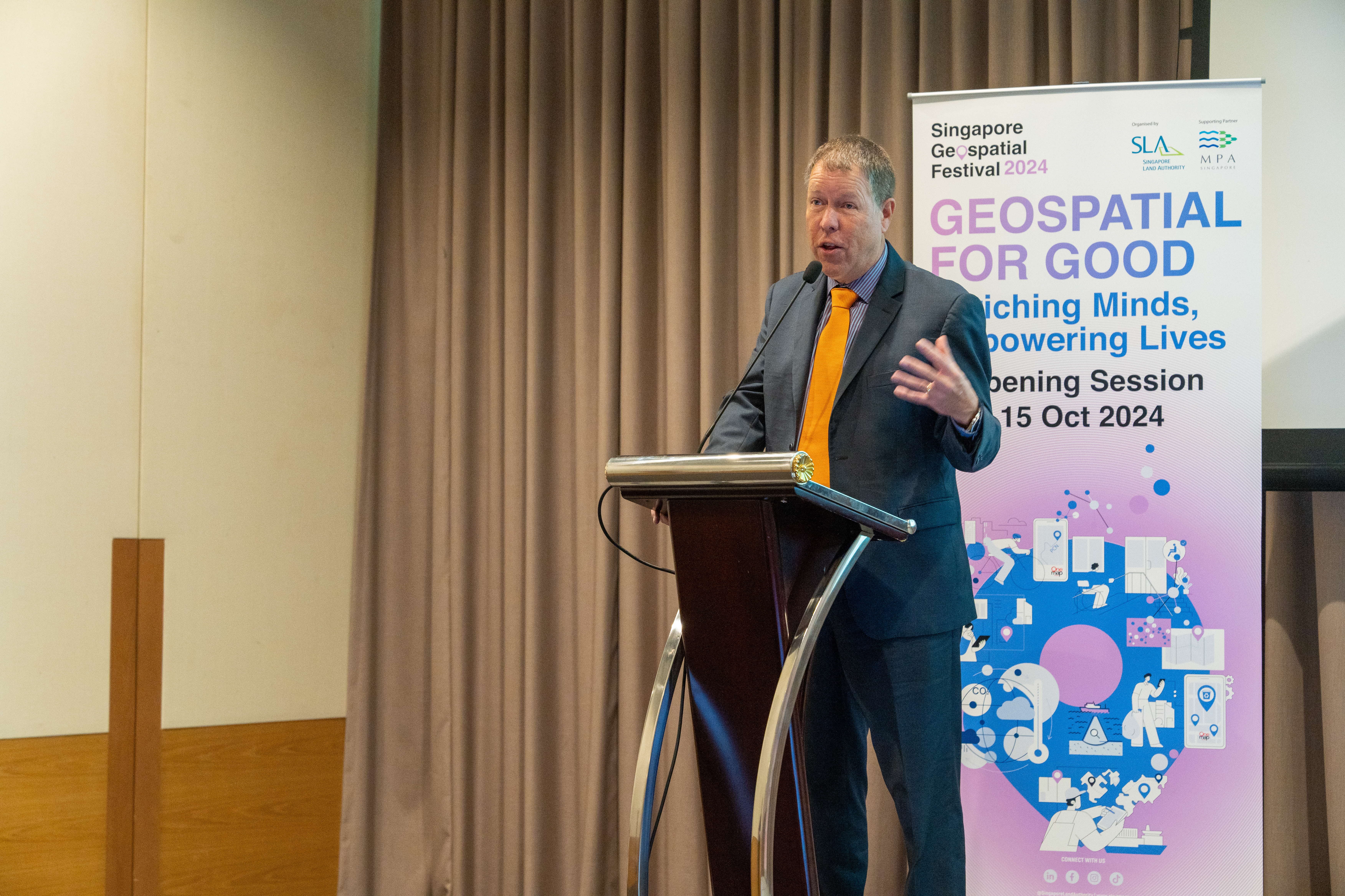 Mr Scott Simmons, Chief Standards Officer of Open Geospatial Consortium at podium.