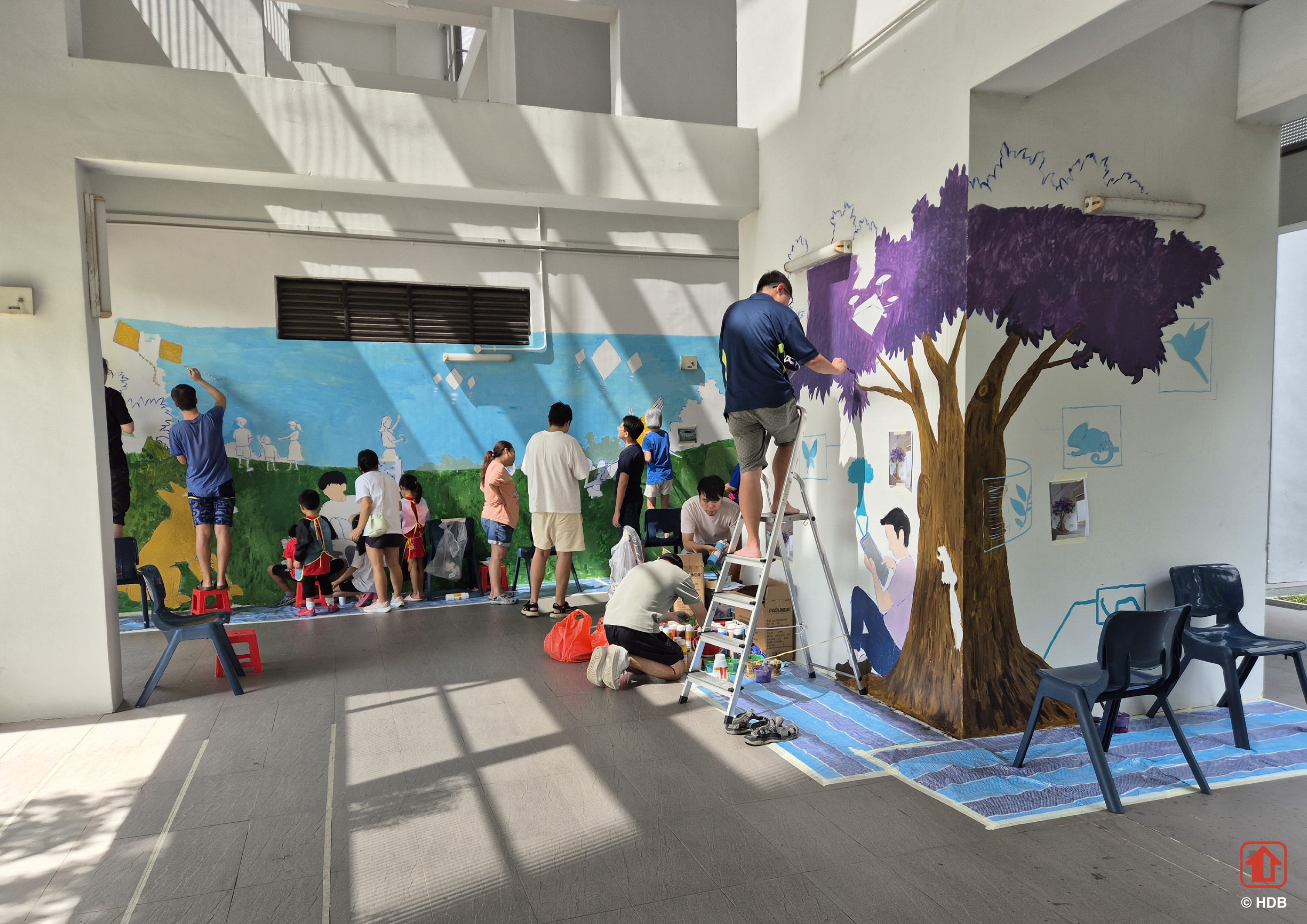 People painting walls of public housing void deck