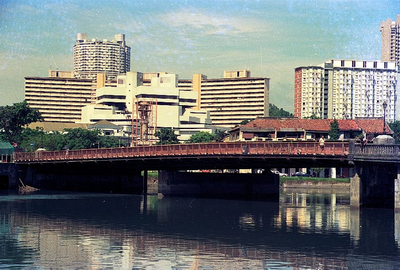 Historic view of Read Bridge crossing the Singapore River, with residential blocks in the background